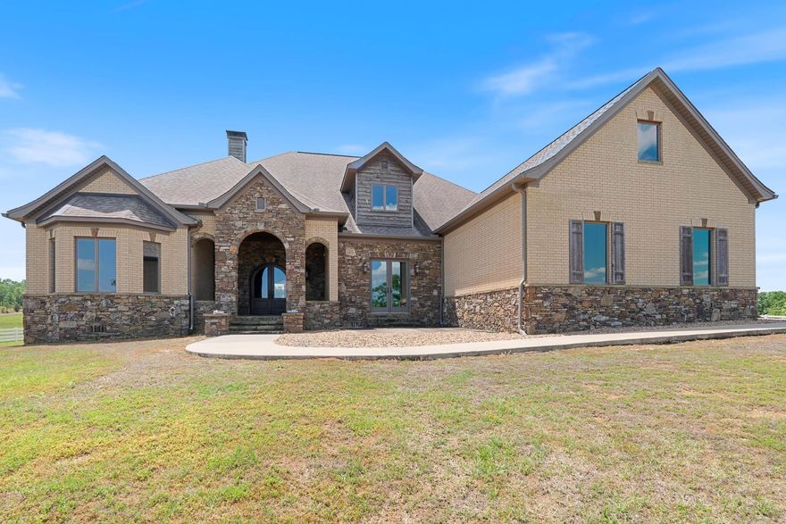 Discover this captivating and private estate, nestled on an expansive five-acre property, secured by a gated entry. The interior of this immaculately designed home is both spacious and sophisticated, boasting three bedrooms, three bathrooms, a media room, & a craft room. The kitchen is equipped with state-of-the-art Thermador double ovens, a gas range, and a concealed refrigerator. The adjacent butler's pantry includes a wine refrigerator, ice maker, & copper sink. The living room is adorned with a stacked stone fireplace, adding to the home's overall allure. The primary bathroom exudes extravagance, featuring a jetted tub and a large walk-in shower with a heated floor. This residence is designed to impress and entertain, both inside & out. The outdoor kitchen, complete with a screened-in room and fireplace, offers an idyllic space for hosting guests. There is a large safe room with a safe door for entry. There is a second safe room below the upper safe room accessible from the garage. The neighboring property will remain undeveloped, as it is owned by the seller, ensuring an unobstructed view. This home is truly a must-see, with numerous high-end features that are sure to impress.