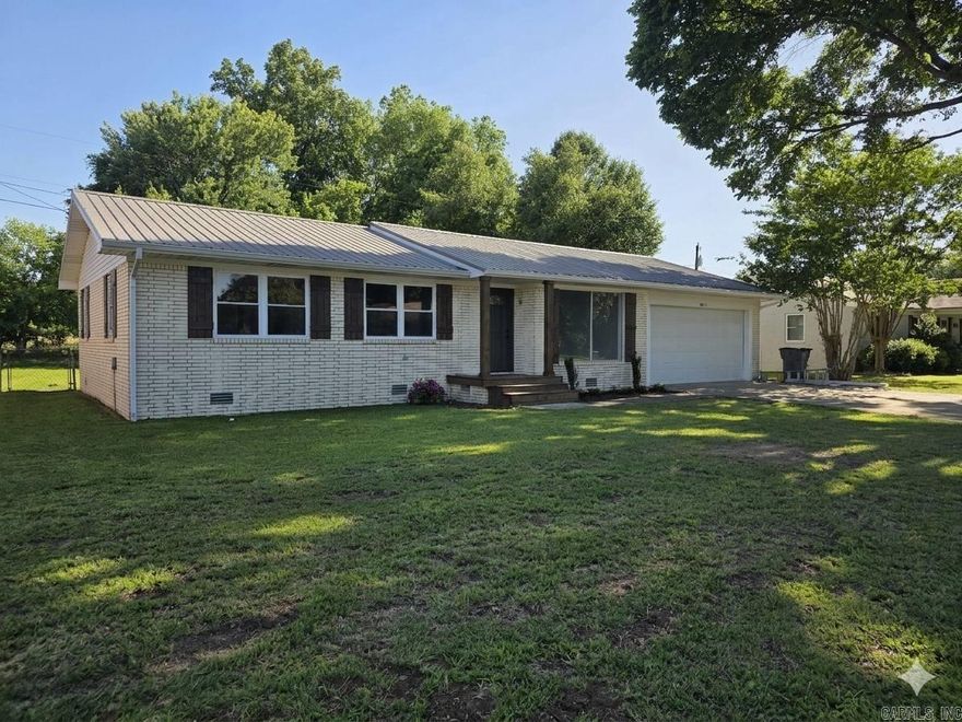 Quality, location, and affordability come together in this beautifully renovated brick home with a metal roof and a true “country feel” while still being in the city. Offering approximately 1,450 sq. ft. +/-, this 3 bedroom, 2 bath all-electric home sits on a spacious .25 acre +/- fenced lot with a two-car garage and large screened-in porch perfect for relaxing or entertaining.  From the studs up, nearly everything inside has been updated. The open kitchen and dining concept flows nicely between the living room and screened porch, while the kitchen features a dedicated coffee station. LVP flooring runs throughout the home, and the solid crawl space foundation adds peace of mind.