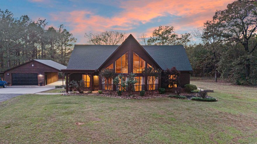 Nestled in a serene setting, this charming 4-bedroom, 2-bathroom log home combines rustic charm with timeless appeal. The spacious living room boasts expansive windows, filling the space with natural light and stunning views. A cozy loft area provides additional flexible space for a home office, reading nook, or creative space. Each bedroom is generously sized with ample closet space. Two detached garages offer abundant space for vehicles, storage, and a versatile workspace. Enjoy the outdoors on the spacious porch. A rare blend of nature and classic living—make it yours today!