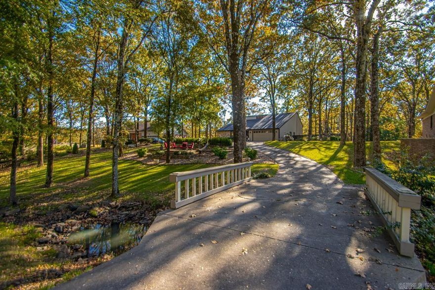 Welcome Home! Tucked away in the heart of North Little Rock in Indian Hills sits a beautifully remodeled home on nearly an acre! Peaceful w/a park-like setting! WOW! You won't find another property quite like it! This picturesque home sits back from the street on a large, private lot w/a meandering creek in the front yard! Inside, enjoy an open layout w/a floor to ceiling stone fireplace, updated super cute kitchen & an additional lower-level living space featuring beautiful custom built-ins! The spacious primary suite provides a relaxing retreat, while two additional bedrooms offer plenty of room for family or guests! Office w/ built-ins perfect for working at home! Outdoors, there are multiple seating areas for firepits, two decks, lots of space to relax, garden or host gatherings under the trees. There is even a charming gazebo ideal for outdoor cooking! Sprinkler system! The perfect blend of modern updates, natural beauty & family friendly charm! You will love it! See agent remarks for lengthy list of updates! Don't miss this one!