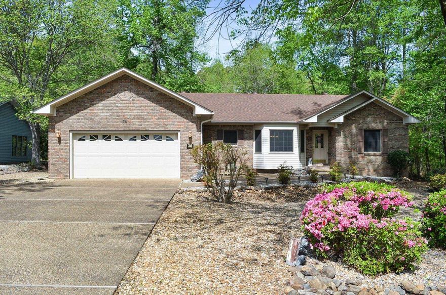 Hot Springs Village is the largest gated community in US and offers fabulous amenities.  9 lakes and 11 golf courses! Walking trails! Fitness Center! Pickleball! This 3 bedroom home has primary bedroom on one side of the house and the 2 guest bedrooms on opposite side.  LVP flooring in entry, dining, kitchen, hallway and laundry.  Vaulted ceiling in main living area creates spacious living.  Roof is 3-4 years old.  The crawl space has been professionally encapsulated.  Oversized garage creates space easily for 2 cars plus golf cart or use the long side in garage for your bass boat or work space!  Located across the street from Lake Pineda shoreline and quick access to the boat launch.