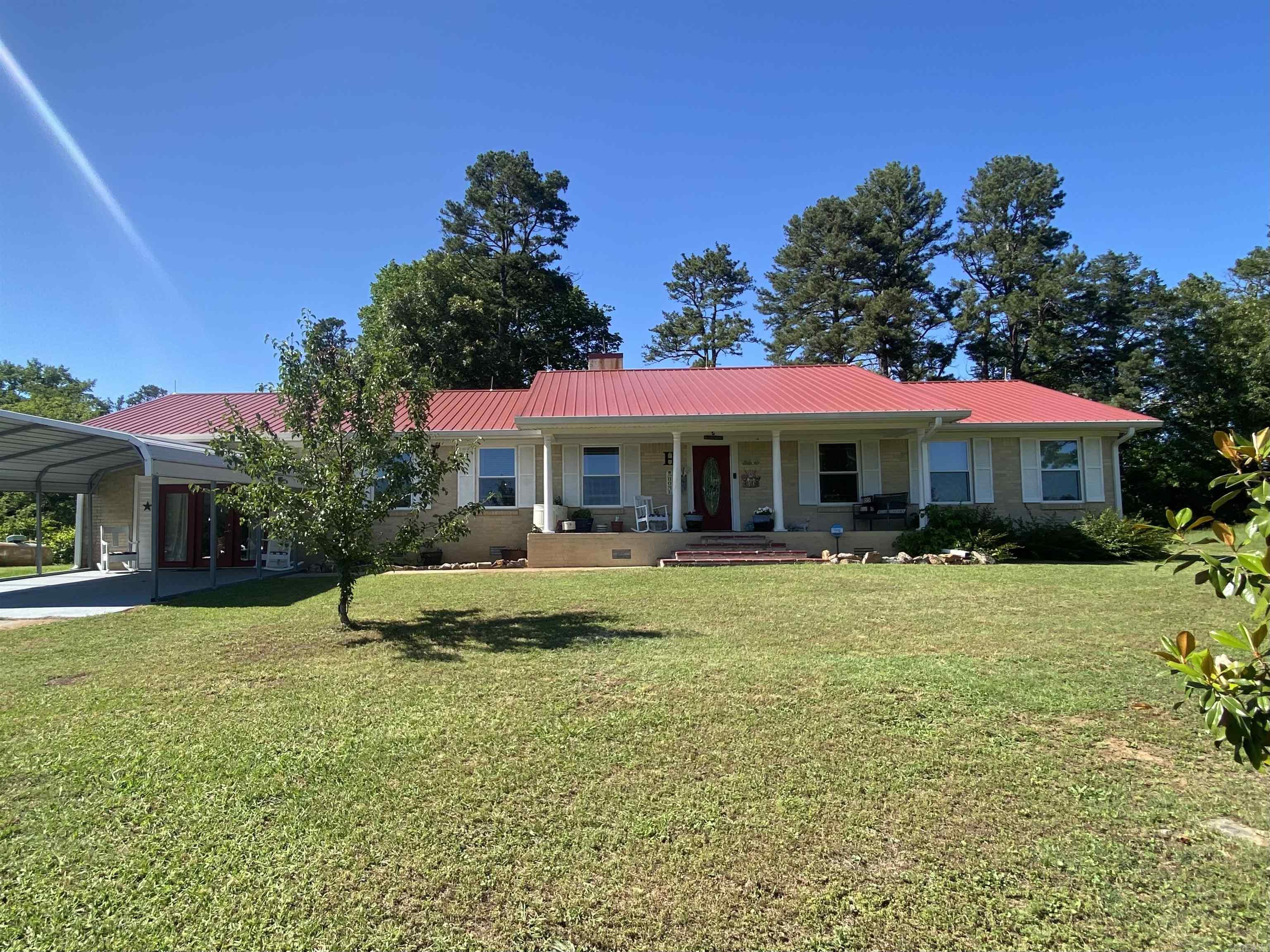 On the hunt for a place at Lake Ouachita, check out 16 Mockingbird Lane, Story, AR. Situated atop and overlooking Deer Creek, which flows right into the lake in the Washita Community, and a view of Lake Ouachita all on 1.90 acres m/l! This 3 bedroom, 2 bath 2200 square foot home has a new metal roof, new windows, new gutters with leaf-guard, and that's just the beginning! The kitchen features lots of cabinet space, a propane cooktop, double oven and stone-coated countertops. The kitchen flows into the large dining room and breakfast room. The dining room and den are super spacious with each having a gas log fireplace. Country elegance is the type you feel in every room of this house, especially in the den where there are shiplap walls and large wooden ceiling beams. All three bedrooms are warm and inviting with lovely wall color and plenty of room to relax. The fenced backyard features an outdoor covered cook area with a fireplace. You are able to walk down the hill across the Corp of Engineers land to Deer Creek. At certain times, you can leave your boat in Deer Creek and go right under the bridge to Lake Ouachita. There are so many extras, you can't miss this one.