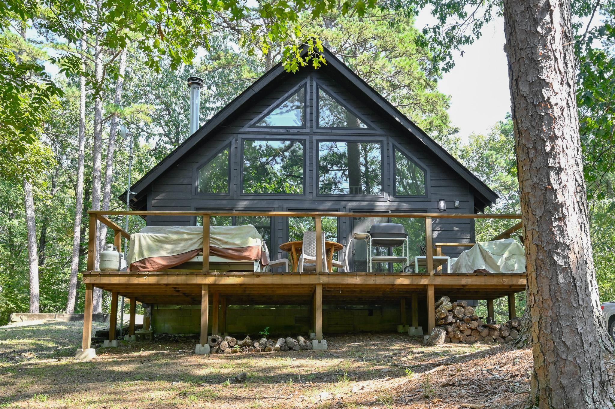 Discover the perfect balance of seclusion and convenience with this beautifully updated two-story cabin just minutes from town. Nestled on 6.53 acres with a pond and surrounded by nature, this property offers both privacy and easy access to local ATV trails. Inside, youāll find a modern yet cozy design featuring vaulted ceilings in the living room with stunning west-facing views and a working vintage MCM Malm wood-burning fireplace as the centerpiece. The open-concept layout includes a loft, two bedrooms, and one bath with a walk-in shower and playful tile flooring. The updated kitchen shines with butcher block counters, new cabinets, an L-shaped design, and modern appliances. A tankless water heater, new plumbing, new electrical, and new siding/paint ensure peace of mind. Step outside to enjoy three spacious decksāperfect for morning coffee, outdoor dining, or simply soaking in the scenery. Additional features include a small dog enclosure, storage shed, and two-car carport. Currently operating as an established Airbnb, this home offers excellent potential as both a private retreat and an income-producing investment. Partially furnished!