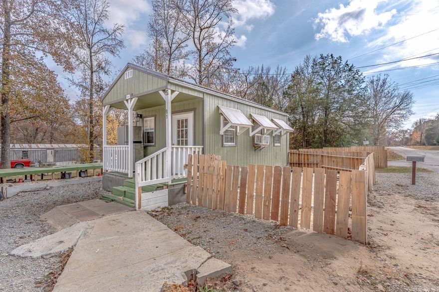 Welcome to Market 81 Lawrence 245 of the Henry Baltz Subdivision in Powhatan, Arkansas. Less than a quarter mile to 645 Acre ± Lake Charles and a mile to Lake Charles State Park. Situated on a .40 ± partially fenced corner lot sprinkled with shade trees is a 2023 built 300 ± sf Cabin Shed wrapped in wood, topped with metal and architectural shingles, and accented by a front porch, back deck, and fenced area for your pets. The interior features a living room and bedroom area and is prepped for a bathroom. Most of the work has been done for you, leaving room for you to customize it to your taste. On site is a 10x22 metal storage building, an 8x20 deck, 2 RV hookups, septic, water, and electric. You'll love living the lake life near beautiful Lake Charles which is renowned for its fish like Largemouth Bass, Crappie, Catfish, and Bluegill. Conveniently located near Highway 412 and just 30 miles to Hardy, and Jonesboro, AR. Call today to schedule your tour and make this tiny house by the lake your home, home away from home, or next addition to your rental portfolio.