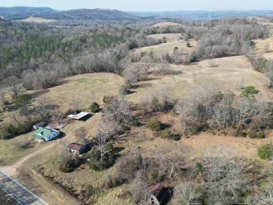 40 acres located in the Ozark Mountains! This property is mostly pasture land that is fenced, has 2 ponds, and some wooded areas! There is an old farmhouse on the property that has 2 bedrooms & 1 bathroom, but the land has multiple building sites!  There is an old barn, storage shed, well, and electric on the property!  Don't miss an opportunity to own a nice piece of ground 7.5 miles from the White River!