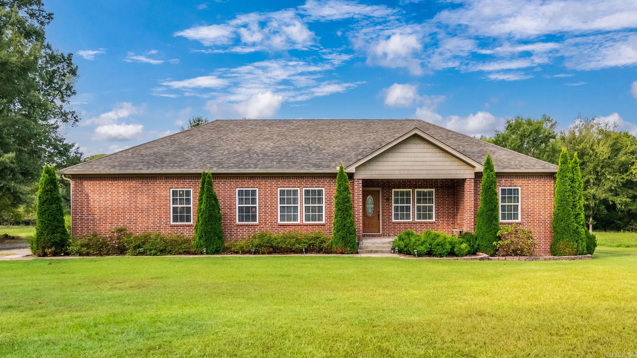 Welcome to your private retreat in the heart of Roland! This charming 3-bedroom, 2-bathroom home sits on a beautiful, flat 5.31-acre lot, offering the peace of the countryside while being just minutes from the Walmart on Chenal and all the conveniences of West Little Rock. Lovingly built in 2005 by it's owner, a fireman, this home was designed with care and character. Step inside to find original hardwood floors throughout the main living areas and carpet in the bedrooms with plenty of natural light. The spacious floor plan includes a bonus room upstairs and an unfinished sunroom downstairs, ready for you to make your own. Recent updates including a brand-new HVAC (2023) and roof (2024). Outdoors, you’ll enjoy the quiet surroundings and wide-open space, with neighboring horses and cows adding to the country charm. Whether you dream of gardening, adding a barn, or simply enjoying the privacy, the possibilities are endless. Don’t miss this rare opportunity to own a slice of country paradise with city convenience. **Agents see remarks**