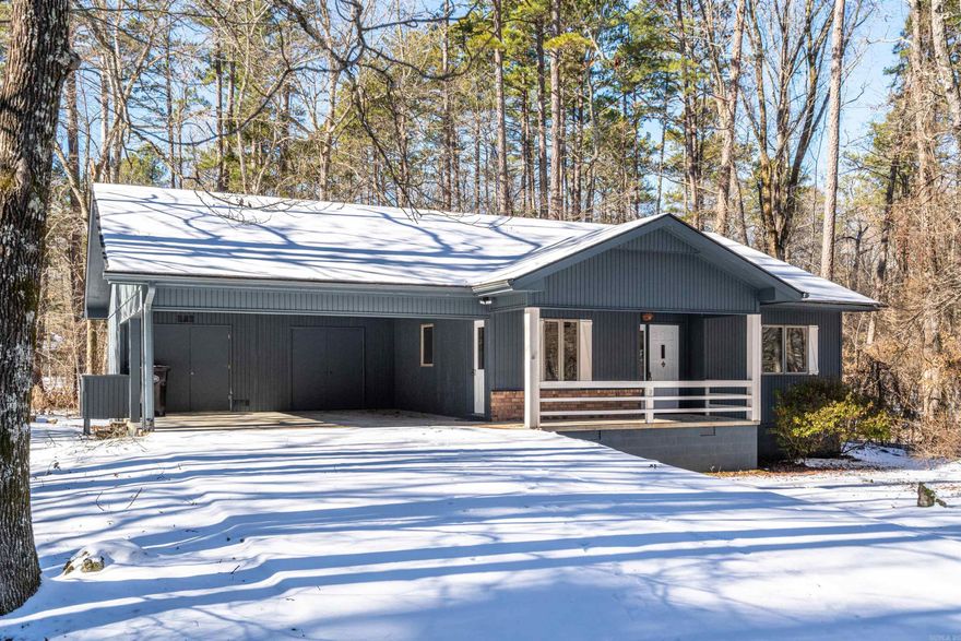 This Hot Springs Village gem captures the essence of modern country living. Nestled in the heart of the village this home comes with Custom Wood Cabinets throughout, Updated with Shiplap, Luxury Vinyl Floors, Windows, Toilets, New Light Fixtures, Interior & Exterior Paint, and the Roof was Recently Replaced.  Built with an oversized carport, a large front porch, an enclosed back porch, and natural landscaping this home is move-in ready!   *There is an additional room that could also be used as a 3rd bedroom or office.