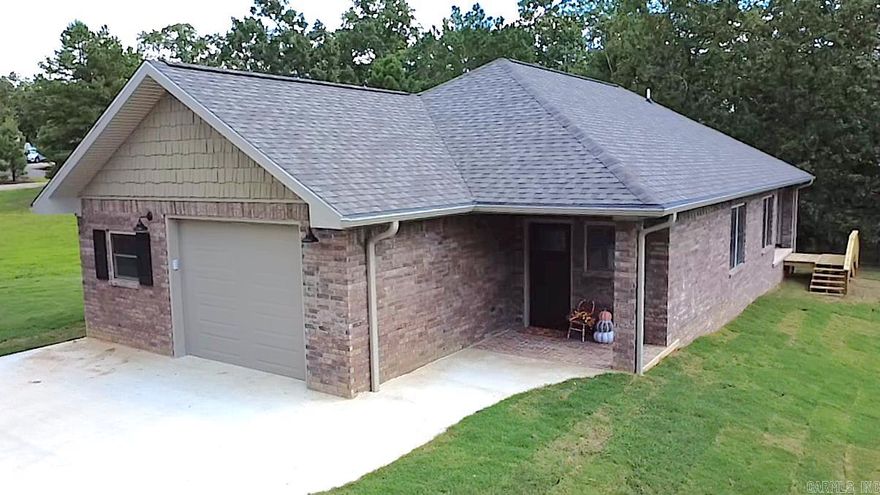 Beautiful new construction home sitting on 1.21 ac in the desirable Timber Ridge subdivision in Mena! The charming brick floor of the front porch welcomes you in to this 3 bedroom, 2 bath home featuring 1,490 sq ft of thoughtfully designed living space. Inside, you’ll find luxury vinyl plank flooring throughout, solid wood cabinetry, and gorgeous granite countertops in the kitchen and baths. The primary suite features a custom tiled shower for a spa-like feel and a large walk-in closet. Extras include a spacious laundry room and additional storage room off the garage. Outdoors, enjoy the covered back porch with a scenic view looking down the valley. Sitting on 3 lots, this property provides extra space for relaxing, entertaining, or gardening. A perfect blend of quality craftsmanship and modern finishes—ready for you to call home!