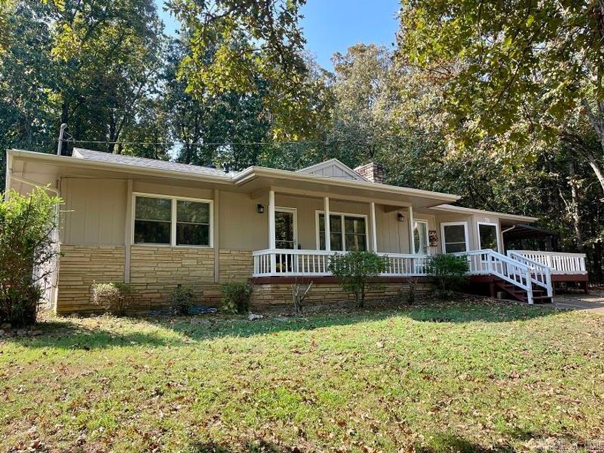 Discover your perfect retreat in this charming 2-bedroom, 2-bathroom home featuring 1,486 square feet of comfortable living space.  The living room features original hardwood floors and a gas-log fireplace.  The thoughtful layout includes a second living area w/another fireplace, giving you flexibility for entertaining guests, a cozy reading nook or a home office, the possibilities are endless.  Recent updates showcase the pride of ownership throughout. A new roof installed in 2023 keeps everything snug and dry, while fresh exterior paint completed in 2025 gives the home a crisp, welcoming appearance. New windows and doors in the main part of home were installed in 2023 enhance both energy efficiency and curb appeal, complemented by new gutters and gutter guards that handle Arkansas weather with ease. The kitchen offers plenty of cabinet and countertop space along with newer appliances.  The HVAC system was replaced approx. 5 years ago ensuring year-round comfort. The front deck, freshly painted in 2025, provides the perfect spot for morning coffee or evening conversations.  Newer back deck is very peaceful with a private setting.  New septic tank installed 2 years ago as well.