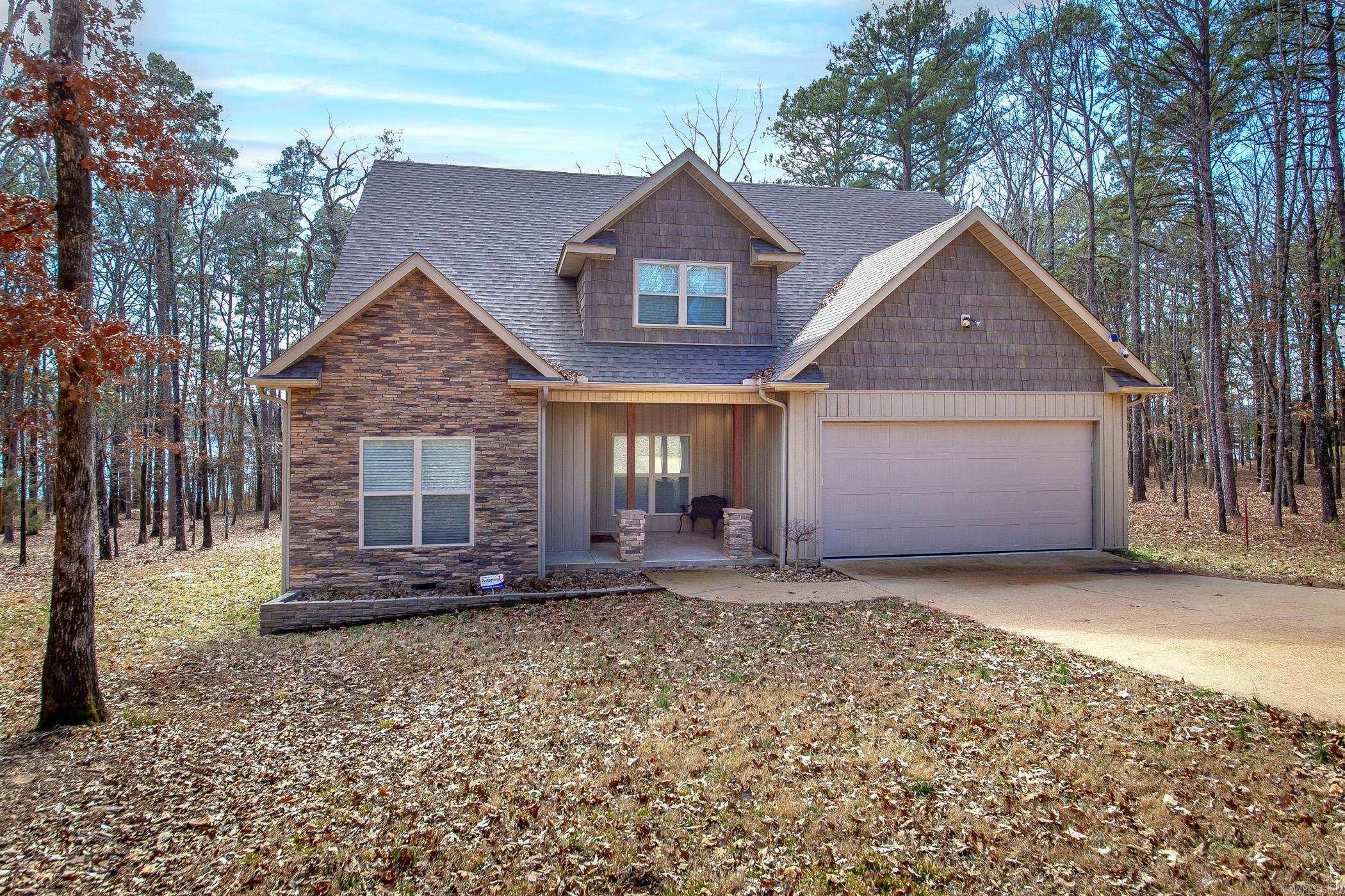 Welcome to your dream lakefront retreat in the Tannenbaum Community on the picturesque Greers Ferry Lake. This exceptional home combines the tranquility of nature w/ modern conveniences, offering an unparalleled lifestyle. Step inside to discover a haven that promises both relaxation & entertainment. Begin your day on the expansive screened-in back deck, savoring your morning coffee as the sun rises over the serene waters. After a day of lake adventures, unwind in your private hot tub, soaking in the breathtaking views that surround you. Designed for ease & convenience, this low-maintenance home features an oversized garage, perfect for storing your boat & vehicles. The fully furnished interior showcases a blend of comfort & style, with a kitchen that boasts elegant cherry cabinets with soft-close doors & gleaming luxury vinyl plank flooring throughout. Efficiency meets innovation with all-LED lighting, WiFi thermostats, two heat pumps, & a robust 200-amp service. Additionally, two unfinished rooms upstairs offer the potential to add additional living space. Convenience is at your door step with a nearby boat launch. When not on the lake enjoy a round of golf.