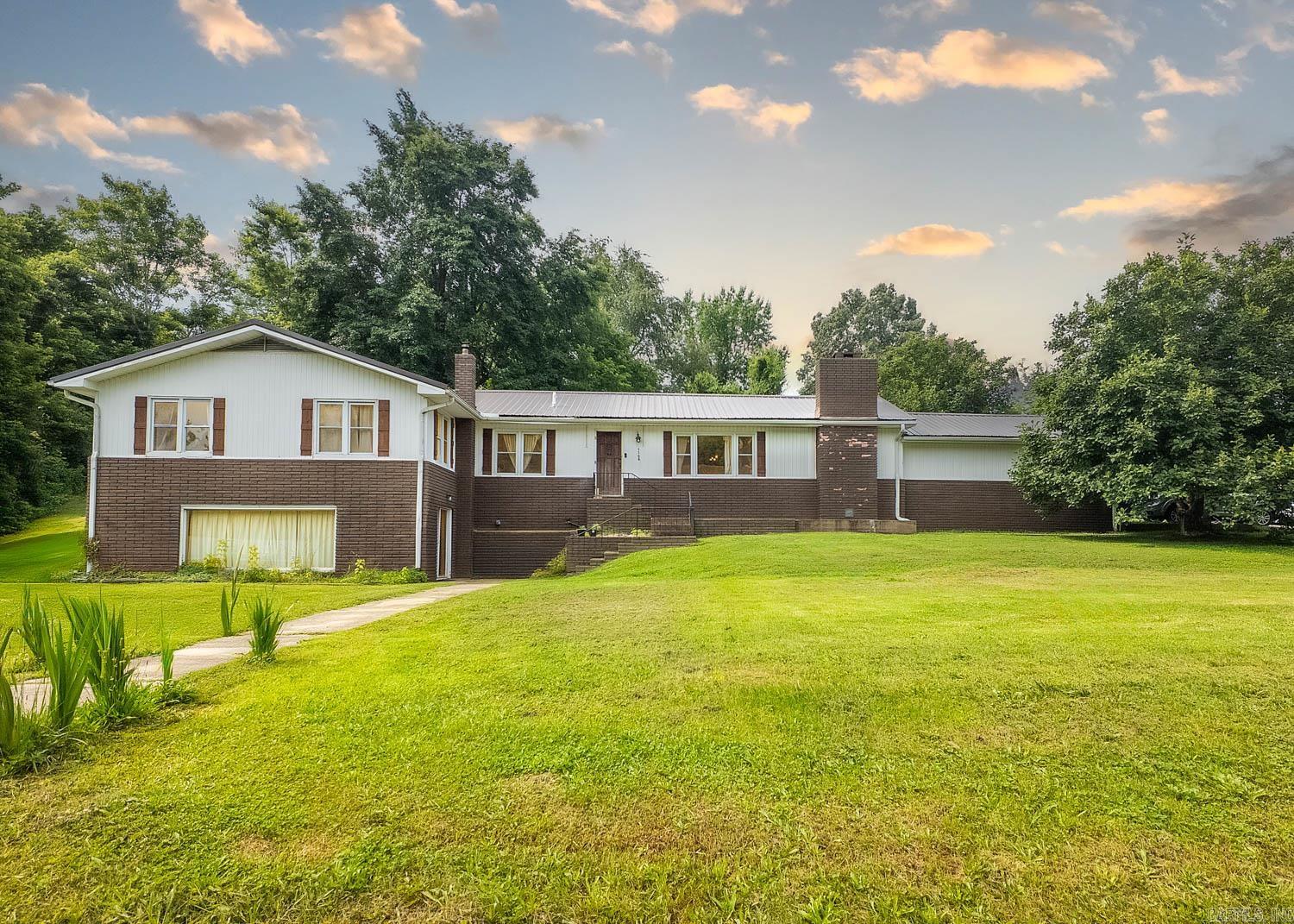 Spacious 5-Bedroom Home Near Spring River If you're looking for space, comfort, and convenience, this 5-bedroom, 3-bath home in town checks all the boxes. Tucked away on a quiet street with minimal traffic, the property offers a peaceful setting while still being close to everything you needāMain Street, schools, and local attractions. The main level features an open-concept layout perfect for everyday living and entertaining. The kitchen overlooks the dining area, which includes a cozy propane fireplace insert, and flows seamlessly into the spacious living room. A large bar ties it all together, creating an ideal spot for family gatherings or hosting guests. All primary bedrooms are located on this level, making daily routines simple and efficient. Downstairs, the finished walk-out basement adds incredible flexibility with two distinct spacesāperfect for a second living area, home office, or den. One side includes a wet bar, ideal for entertaining or creating your own game room. Enjoy the large front yard with ease, thanks to the peaceful neighborhood setting. Plus, you're only minutes from Spring River access and the scenic Mammoth Spring State Parkāperfect for outdoor fun.