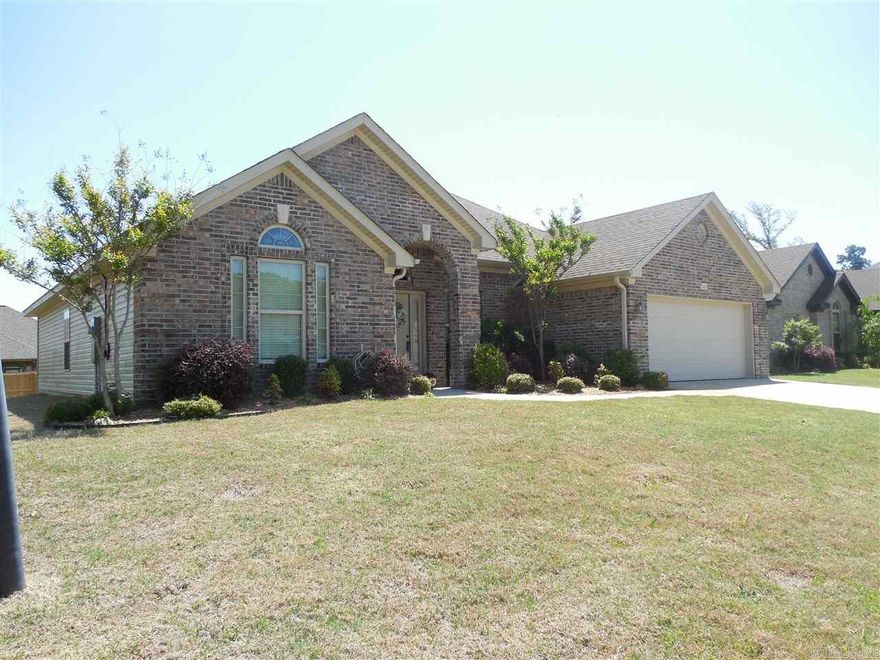 Custom built with stained cabinets, stainless steel appliances, granite counter tops, Hardwood floors in entry and living room, tile flooring in all wet areas, carpet in bedrooms. Large open split floor plan. Hall bath with double vanities. Master bath with double vanities, jetted tub and walkin shower with his/her walkin closets and extra 3rd closet. Lots of crown molding and crown caps throughout. Large covered patio with level lot and built in fire pit. Bryant School District, close to I-30 and shops.