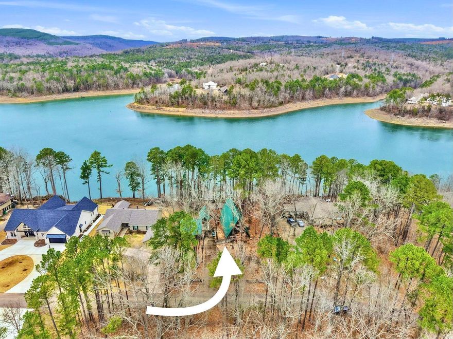 When you think "Lake-House", A-Frames are a nostalgic design that comes to mind.This A-Frame is so cozy, has a wood burning fireplace, LAKEFRONT (with White Line in the water, so more trees can be cut to open the view up even more), Lake Views from the cabin & decks, plus steps down to the water. For many years the cabin has been setup to be used as a 3 bedroom (1 Bedroom upstairs above the kitchen w/full bathroom on main level, Primary bedroom downstairs w/a full bathroom & laundry room connected, & 3rd bedroom setup downstairs as well w/walk-out basement onto the lower patio. There is a large room above carport that would make a great Bunkroom/gameroom/craftroom/guest quarters,etc. The home was built in 1988, but Remodeled w/all new LVP flooring throughout the home around 2021,new roof/gutters in 2018,pull blinds installed May 2024,all new kitchen appliances, countertops & cabinets in July 2024, & High-Speed Internet through "Connect 2 First".  Community Boat Ramp & Private Airstrip for property owners in "Skypoint Estates". Option to purchase extra lot across the street for additional $15,000 (Lot 18). See Virtual Tour Website to view videos, Floorplans, & see docs attached.