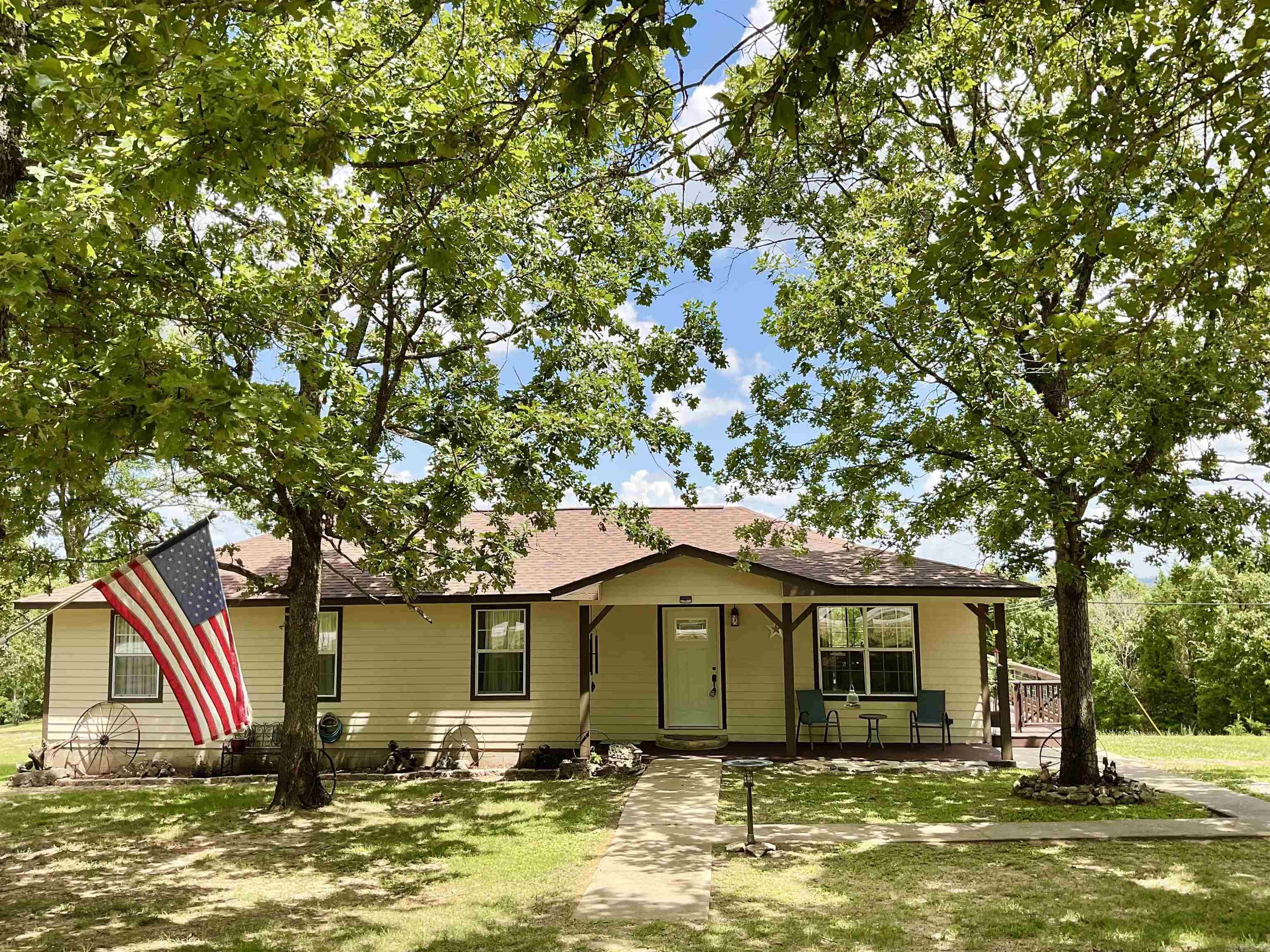 PRIDE OF OWNERSHIP SHINES THROUGH this move in ready 4 bedroom 2 bath home! Great layout with the open Kitchen, living, dining with a beautiful vista view out the patio doors, and a large wrap around deck to enjoy the outdoors and cooking out. 4 bedrooms gives plenty of room for guest coming to visit and enjoy the lake. This home is so fresh and clean, with new paint, New roof in fall of 24, new light fixtures, new heat and air, new plumbing under home with sealed plastic ground cover. New well pump and lines. New storage building and another building for tools and storage. There is also a hookup for a RV, all on nearly 6 acres of unrestricted property to call your own. Come take a look! it will feel like home. Recently added New Dishwasher, cook stove, and microwave. Fresh paint on deck and front entry and a New front door! New curtains in living room and Patio doors. Check out the new pics.