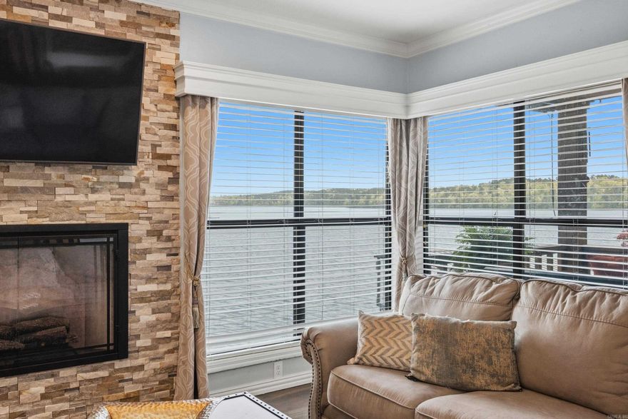 TOTAL UPDATE, PERFECT UNOBSTRUCTED VIEW OF LAKE HAMILTON, PERFECT LOCATION OFF 7 SOUTH. Turn onto Lakeland Drive (halfway between WALMART and KROGER....location  doesn't get any better than this!) Unit A-3 is WALK IN LEVEL.  2 BR 2 BA in established complex with gated entrance, pool, and NO SHORT TERM RENTALS ALLOWED. No carpet. Comes with COVERED BOAT SLIP WITH LIFT and JET SKI DOCK. Patio faces east to enjoy beautiful sunrises over the water and late afternoon grilling in the shade! Reserved parking right at your front door...no steps! This unit accomodates full size washer and dryer. Electric fireplace. New dishwasher. Newer HVAC , ROOF, AND WINDOWS.  Community pool is getting a facelift as well!  EASY TO SHOW. CALL OR TEXT LISTING AGENT. AGENTS SEE REMARKS