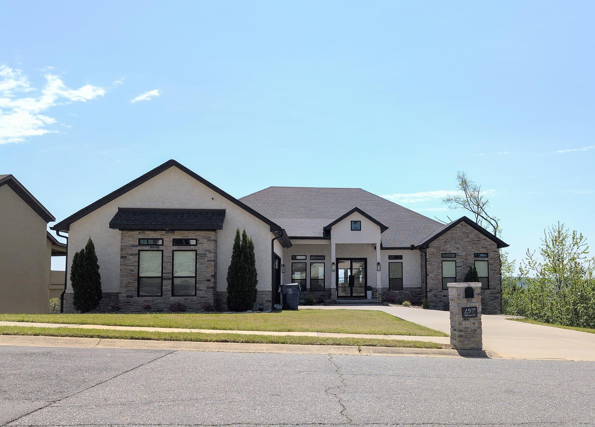 This beautifully designed home offers luxury living with Arkansas river views and a spacious open floor plan—ideal for entertaining and everyday family life. Formal living and dining areas with soaring ceilings welcome you in, while the gourmet kitchen features custom cabinetry, granite countertops, top-tier stainless appliances, gas cooktop, and two wet bars with wine fridges. The split layout offers privacy with a serene master suite, custom closet, and spa-like bath on one side, and three additional bedrooms, an office, and playroom on the other. The finished lower level includes a gym, entertainment space, and access to a private deck. Every room is equipped with built-in Bluetooth speakers—even the garage and patio. With 4 bedrooms, 4.5 baths, and thoughtful upgrades throughout, this is the perfect place to call home. Highly Motivated Sellers!
