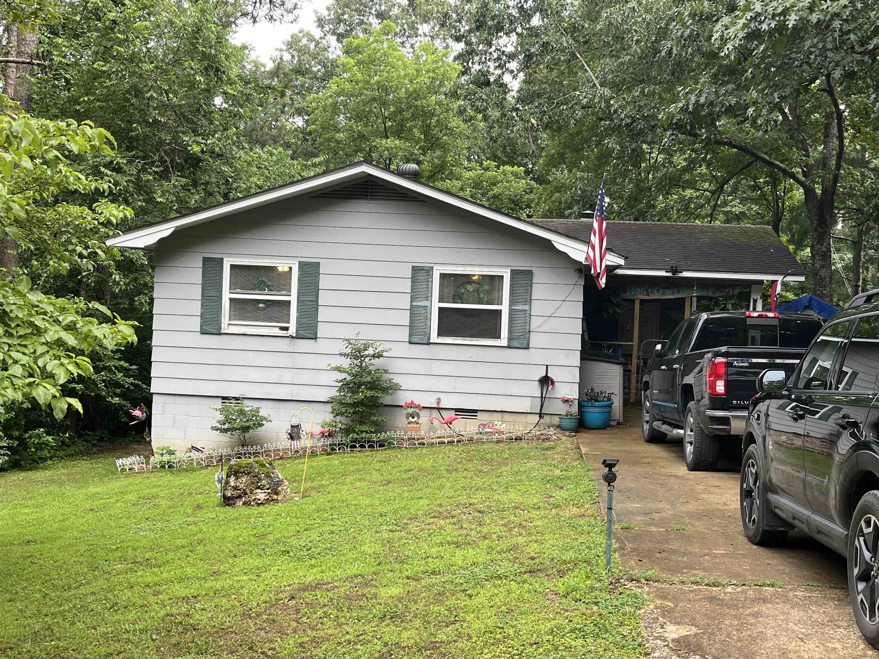 REDUCED!!! Tucked away on the outskirts of town, this cozy 3 bed/1.5 bath home offers the perfect blend of peaceful seclusion and convenient access to amenities. This listing includes 2 additional lots for plenty of nature. Enjoy your morning coffee or evening unwind on the large deck, where the sights and sounds create the ultimate backdrop. Inside a wood-burning fireplace adds warmth and rustic charm to the inviting living space. The converted carport serves as a delightful gathering place-ideal for entertaining or simply relaxing with friends and family. The home also features a large dog run, perfect for your furry companions. Under the deck, access a partial unfinished basement area perfect for a workshop or hidey hole. Tool room also at the end of the carport. Whether you're looking for privacy, space to expand, or a quiet retreat that's just minutes from town, this property offers it all. Contact your favorite agent to schedule a view. MOTIVATED SELLER