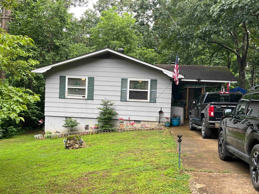 REDUCED!!! Tucked away on the outskirts of town, this cozy 3 bed/1.5 bath home offers the perfect blend of peaceful seclusion and convenient access to amenities. This listing includes 2 additional lots for plenty of nature. Enjoy your morning coffee or evening unwind on the large deck, where the sights and sounds create the ultimate backdrop. Inside a wood-burning fireplace adds warmth and rustic charm to the inviting living space. The converted carport serves as a delightful gathering place-ideal for entertaining or simply relaxing with friends and family. The home also features a large dog run, perfect for your furry companions. Under the deck, access a partial unfinished basement area perfect for a workshop or hidey hole. Tool room also at the end of the carport. Whether you're looking for privacy, space to expand, or a quiet retreat that's just minutes from town, this property offers it all. Contact your favorite agent to schedule a view. MOTIVATED SELLER