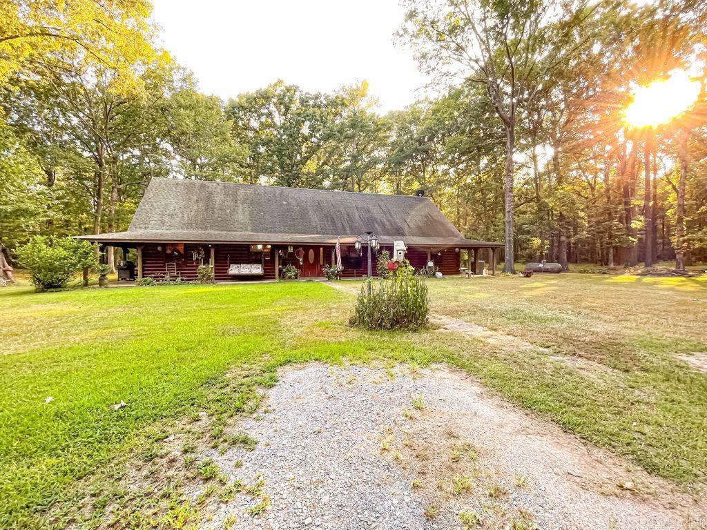 Enjoy peace, privacy, and natural beauty in this beautiful 3-bedroom, 2 bathroom log cabin set on 13.45 acres. This homes features a large kitchen, spacious living room, and an open loft perfect for extra living space or a home office. Enjoy watching wild turkey and deer roam the property from your back porch! Outside, two 20x30 shops with a connecting awning providing ample space for storage, hobbies, or a workshop. A full home generator ensure year-round comfort and reliability- if you are looking for something outside of town this the home for you!