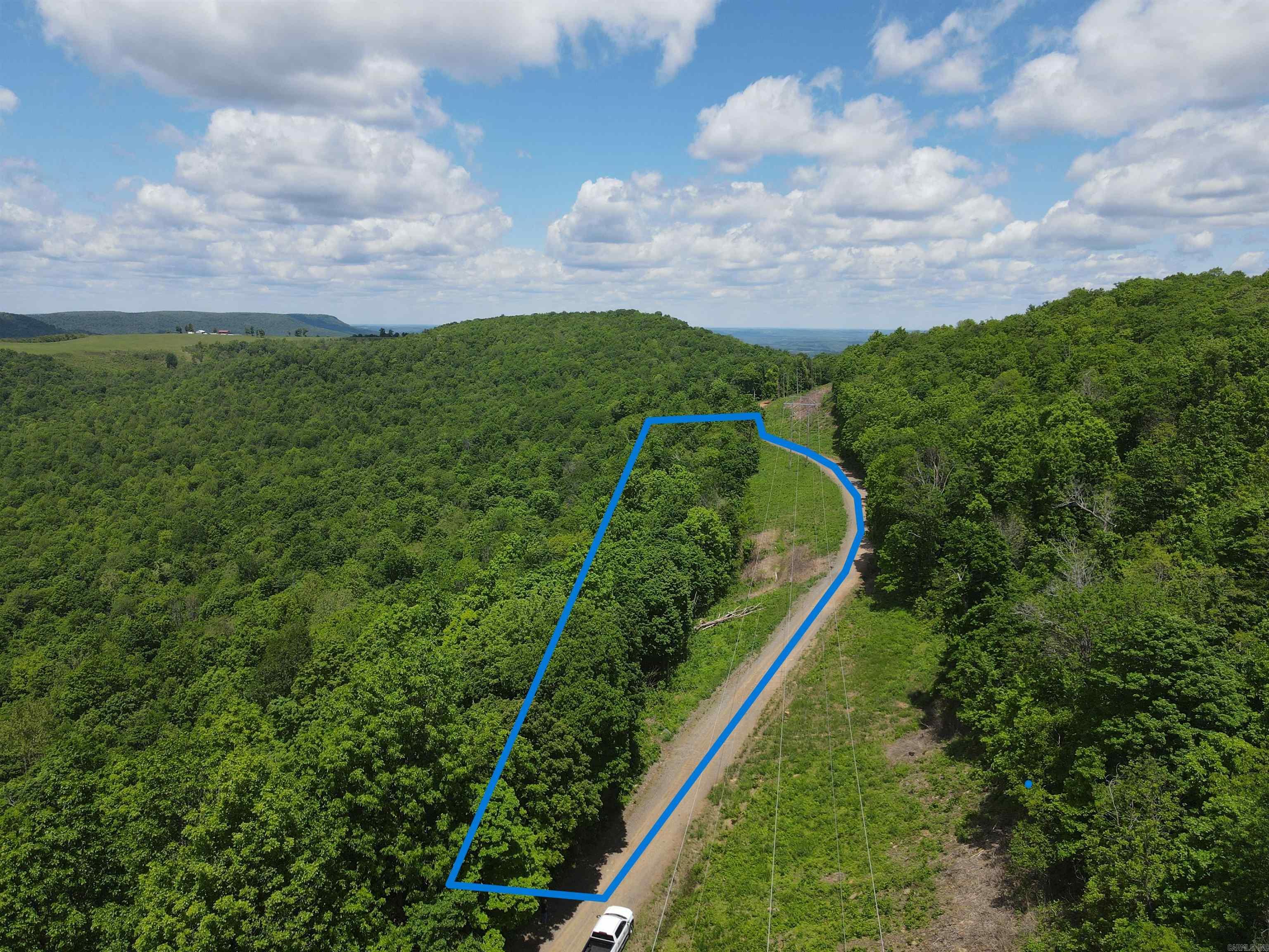 This 7-acre (+/-) property offers a peaceful setting with gravel county road frontage on Lick Fork Road. With electric and high-speed internet already available, it’s ready for your dream home or getaway cabin. The land showcases beautiful views of the surrounding countryside, making it an ideal spot for those seeking a scenic, rural lifestyle.