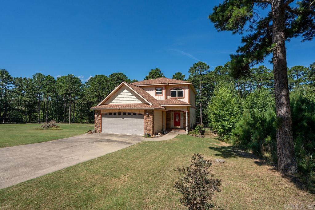 Lakefront living across from Thunderbird Country Club and Golf Course! This custom-built 4 bed, 3 bath home sits on a level 1.71-acre lot with two path permits and a good beach areaāperfect for lake enjoyment, easy walk to the water with your canoe, kayak or lounge chair. With 2,348 sq ft, it features bamboo floors, upscale tile, granite countertops, custom cabinetry, and exquisite lighting throughout. Bathrooms showcase unique tile work, with motion-sensor lighting. One bedroom is on the main floor, the other 3 are upstairs. Two decks for outdoor entertaining, 2-car garage, spacious yard. Storm shelter under the house, extra stove and sink in the garage for additional cooking space. Recent updates include a new wrought iron fenced backyard (2024), HVAC systems (2022 & 2023). Roof is believed to be original from 2015. Convenient to boat launch area and across the road from golfing and club swimming pool!