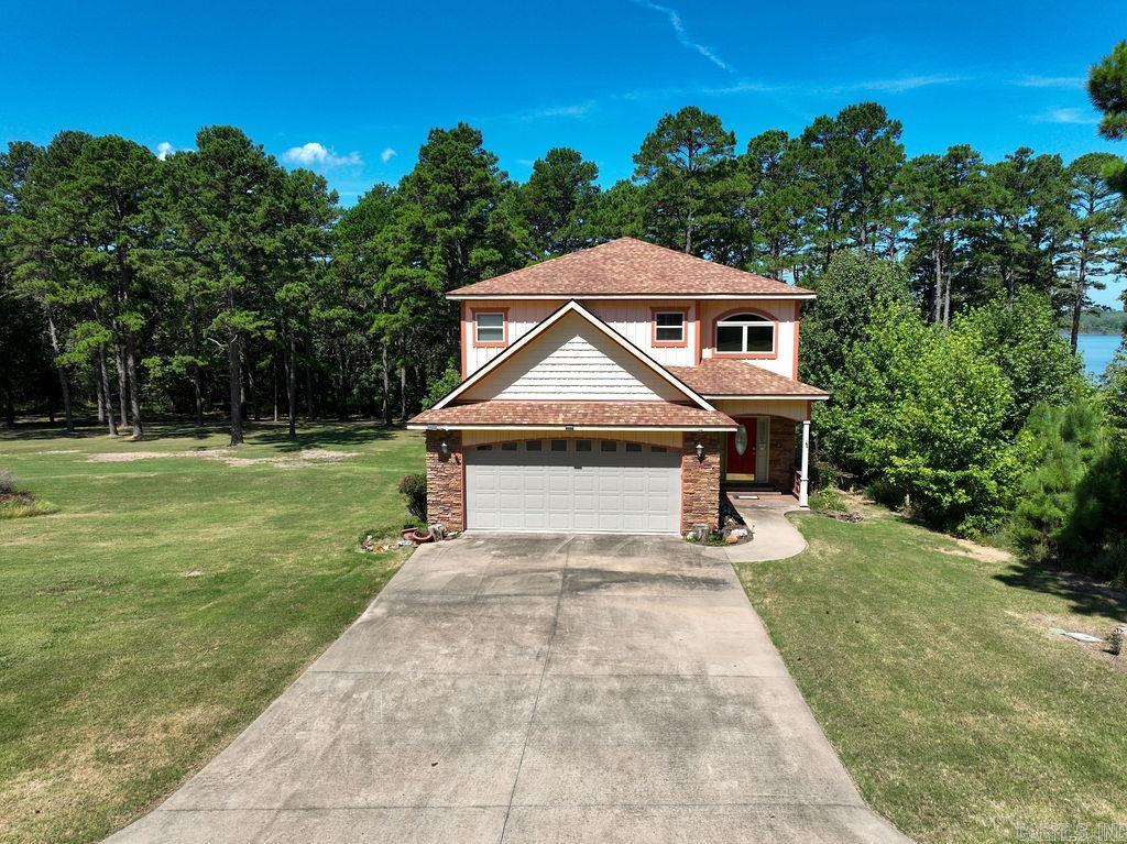 Lakefront living across from Thunderbird Country Club and Golf Course! This custom-built 4 bed, 3 bath home sits on a level 1.71-acre lot with two path permits and a good beach areaāperfect for lake enjoyment, easy walk to the water with your canoe, kayak or lounge chair. With 2,348 sq ft, it features bamboo floors, upscale tile, granite countertops, custom cabinetry, and exquisite lighting throughout. Bathrooms showcase unique tile work, with motion-sensor lighting. One bedroom is on the main floor, the other 3 are upstairs. Two decks for outdoor entertaining, 2-car garage, spacious yard. Storm shelter under the house, extra stove and sink in the garage for additional cooking space. Recent updates include a new wrought iron fenced backyard (2024), HVAC systems (2022 & 2023). Roof is believed to be original from 2015. Convenient to boat launch area and across the road from golfing and club swimming pool!