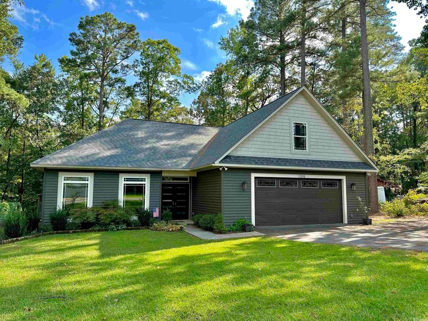 CUSTOM BUILT HOME, IN WHITE HALL! This home comes with 2 lots, one lot undeveloped for privacy in addition to 1.5ac. behind the house for a total of 2.63ac of land. Custom details throughout: 7ft tall windows, custom trim work & granite, with tons of storage. Downstairs: over sized master suite, 2 large walk-in closets & a small office. Upstairs: large TV room, 2 bedrooms, & a full bath. Stained concrete flooring downstairs & LVP flooring up stairs. Brand new roof. Huge covered back porch for entertaining. 16x21 shop with lean-too and camper shed. Don't miss your chance on this Home, call today to schedule your own private tour!