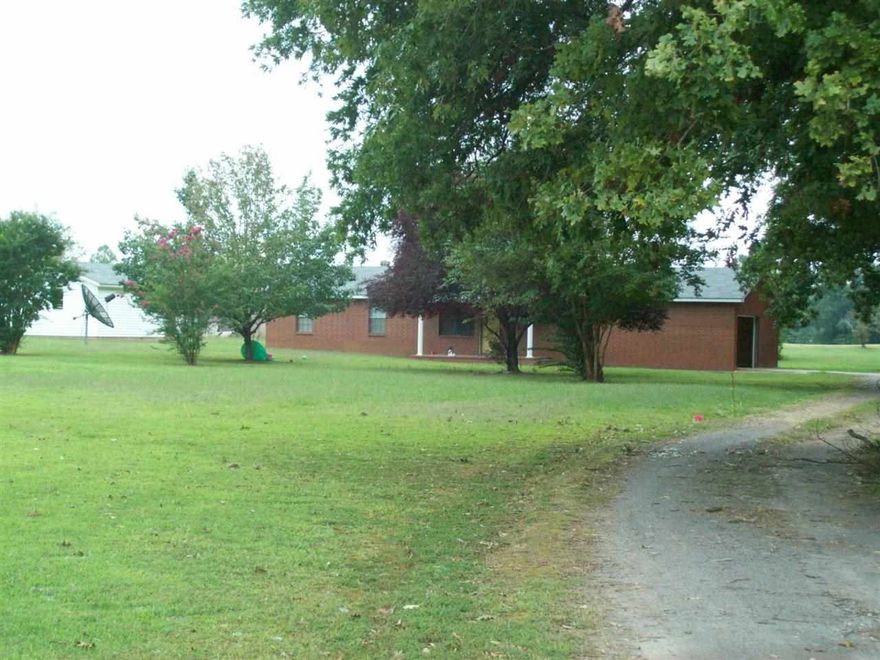 Cozy 2 bedroom 2 bath home with large eat-in kitchen with lots of cabinets, large laundry room, plenty of storage space, great back porch to sit and enjoy the outdoors,  2 20x12 buildings, 1 16x24 detached garage, sitting on 7 acres with half timer the other half cleared.