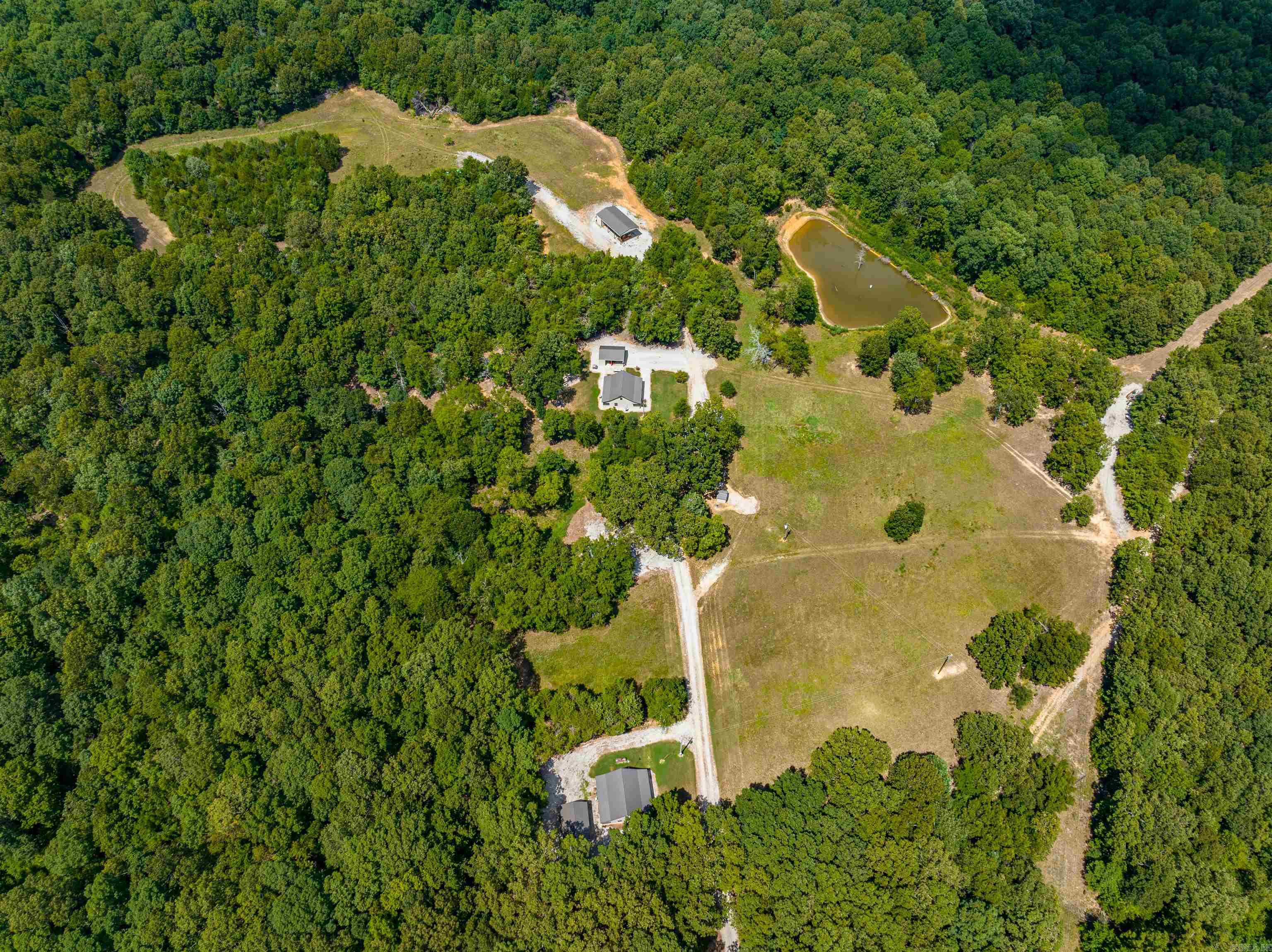 Turn-key Hunting Operation, bring your hunting equipment ready to start enjoying your game-rich property!We offer 1930 +/- Acres, which are all wooded except for a few well-placed food plots and ponds.The property is one of the largest privately owned contiguous timber tracts in the Central Ozarks, with 7 ponds, several springs, deer stands & feeders, a perimeter fire lane, Cabins, and 35 miles of interior roads and trails, all behind locked gates 3 very nice cabins on the property can accommodate 10-15 people. Each cabin also has a storage shed, and 2 have a carport with outdoor space. There is a walk-in cooler for all your game after the hunt. There is also a skinning rack located beside the cooler. Across the driveway is the well shed, which runs water to all cabins. Down at the end, there is also a machine shed that houses a John Deere 5606, cabbed tractor, 4 wheel drive with attachments, and a Case 650K, cabbed bulldozer that will all stay with the property as a packaged deal, and there is a storage shed attached as well.