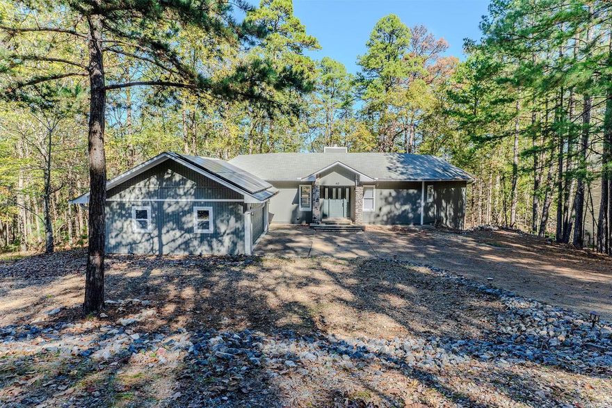Discover your haven of peace in this remodeled 3-bedroom, 3-bathroom home with an open-concept design. The upper level offers panoramic views from every room, featuring 2 bedrooms with private en-suite bathrooms and luxury laminate wood flooring throughout. The modern kitchen boasts stunning granite countertops, and every room provides access to the expansive deck, perfect for relaxation and entertaining. The fully finished walkout basement includes a separate office, an additional bedroom with a full bathroom, and a kitchenette, making it an excellent option for a rental space. The home is equipped with newer HVAC and water heater for your comfort. Situated on a quiet street at the northern edge of Hot Springs Village, this home is only minutes from the West Gate and close to lakes, dining, hiking trails, and golf courses. Don’t miss the chance to enjoy the tranquility and amenities Hot Springs Village has to offer!