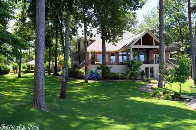 If you want to live on Lake Hamilton with over 200 ft of shoreline, come see this lake home with sweeping views of the lake and mountains. It is located in one of Hot Springs' finest gated subdivisions on Lake Hamilton. Open floor plan, master bedroom on main level, a kitchen for entertaining and cooking, a wood burning fireplace. This waterfront property consists of one and one half lots providing room for a swimming pool or addition. Owner/Agent