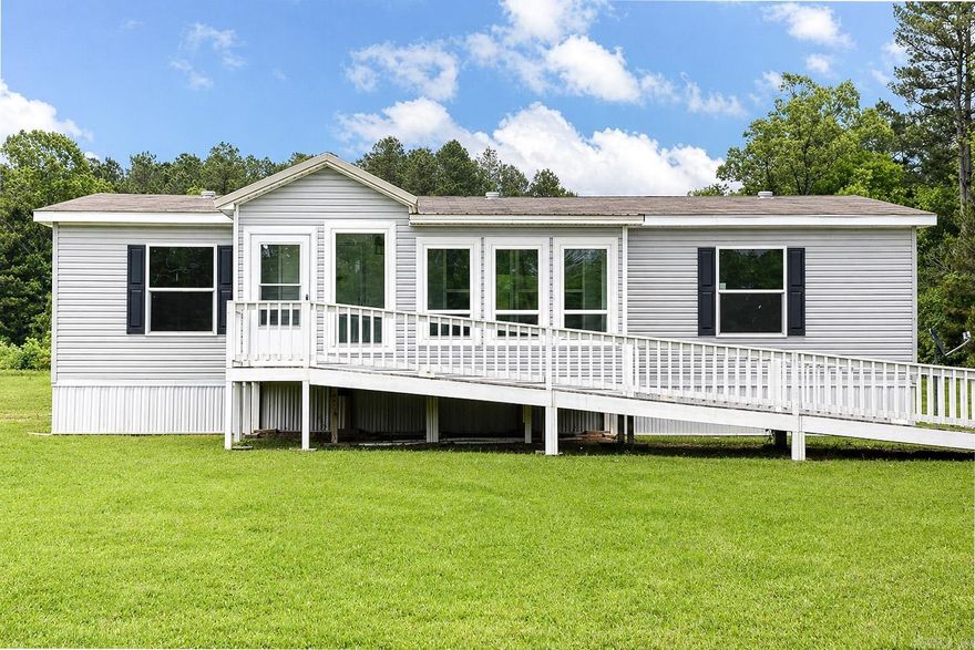 WELCOME HOME to this like brand new 2019 3BR/2BA manufactured home situated on 3 acres, offering peaceful country-style living with plenty of room to enjoy the outdoors. This home features a spacious open-concept layout with rustic-style flooring, neutral finishes, recessed lighting, and a bright kitchen designed for everyday comfort. The kitchen offers a large center island, generous cabinet space, dark lower cabinetry, light upper cabinetry, coordinating countertops, and appliances that stay with the home. A standout feature is the enclosed SUN PORCH, filled with natural light and surrounded by windows overlooking the property. The sun porch windows include a LIFETIME WARRANTY, adding extra peace of mind for the next owner. The home also includes an exterior ramp for convenient access, extra large windows for beautiful views, and a storage building on the property. All appliances including refrigerator, washer and dryer convey.  With 3 acres, a 2019 home, included appliances, a large master suite, and a bright enclosed porch, this property offers a wonderful blend of comfort, function, and space at a great price! Call for a showing today!