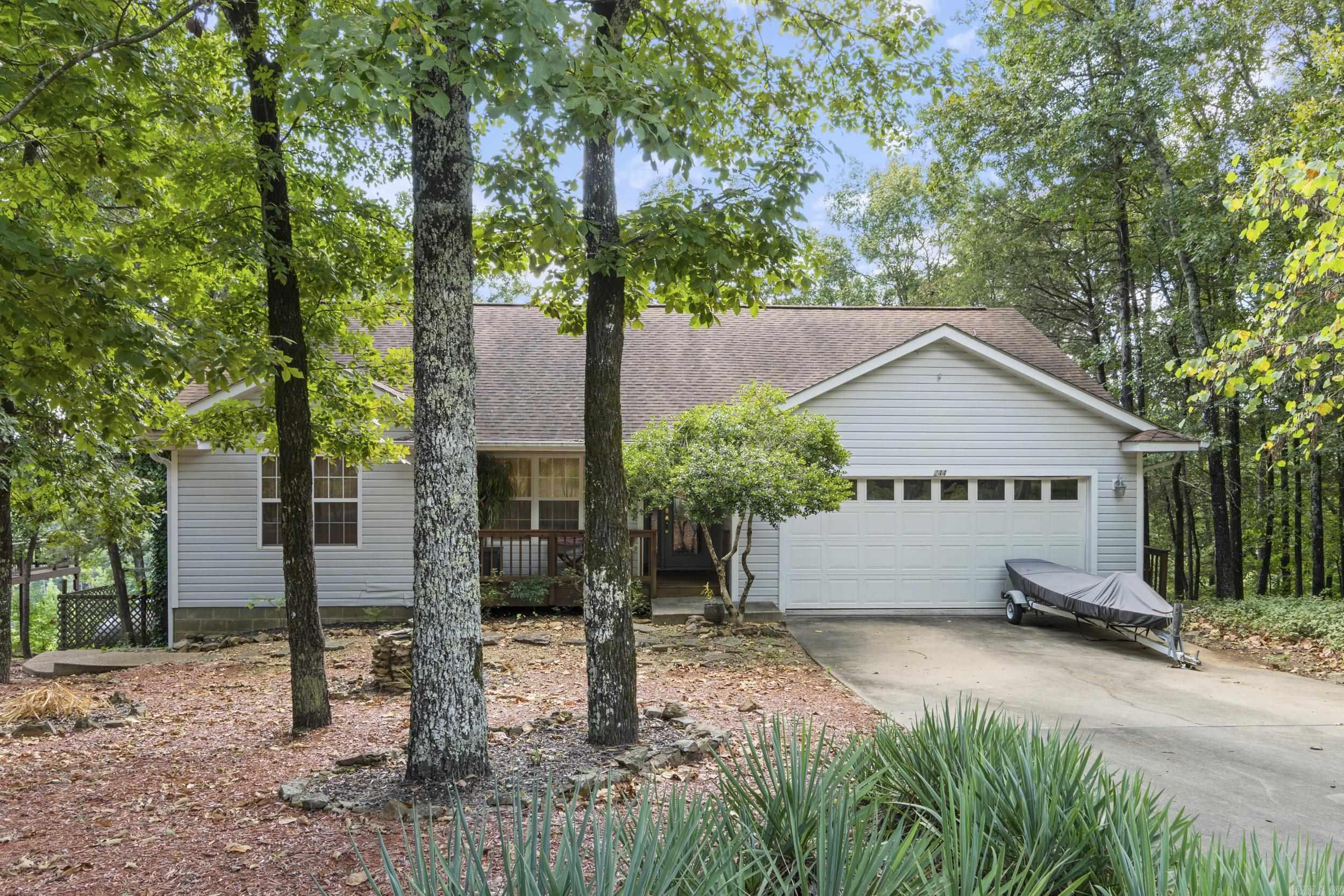 Wake to sweeping Greers Ferry Lake views from this peaceful retreat above Lynn Creek. Enjoy morning coffee on the covered deck, gather with friends around the stone firepit at sunset, and launch your boat just down the roadāabout 5 minutes to Fairfield Bay Marina. The walk-out basement is ideal for a workshop and storage, and extra luxury vinyl plank flooring for the bedroom conveys. One bedroom is currently set up as a music room, offering flexible space for hobbies or a home office. Two additional lots are included, giving you elbow room today and potential for a future shop or outbuildings. Youāre minutes to Indian Hills and Mountain Ranch golf courses and the amenities of Fairfield BayāATV trails, pickleball, tennis, and miles of hiking. Itās a hike to the shoreline, but the big-water and Lynn Creek views make every day feel like vacation. Panoramic views of Greers Ferry Lake. Schedule your appointment to see this home. Additional lots could be sold if not needed but they are currently replatted into one lot providing 1.76 acres. Buyers would need to contact corp of engineers to get path permitted for new owner.