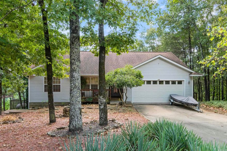 Wake to sweeping Greers Ferry Lake views from this peaceful retreat above Lynn Creek. Enjoy morning coffee on the covered deck, gather with friends around the stone firepit at sunset, and launch your boat just down the road—about 5 minutes to Fairfield Bay Marina. The walk-out basement is ideal for a workshop and storage, and extra luxury vinyl plank flooring for the bedroom conveys. One bedroom is currently set up as a music room, offering flexible space for hobbies or a home office. Two additional lots are included, giving you elbow room today and potential for a future shop or outbuildings. You’re minutes to Indian Hills and Mountain Ranch golf courses and the amenities of Fairfield Bay—ATV trails, pickleball, tennis, and miles of hiking. It’s a hike to the shoreline, but the big-water and Lynn Creek views make every day feel like vacation. Panoramic views of Greers Ferry Lake.  Schedule your appointment to see this home.  Additional lots could be sold if not needed but they are currently replatted into one lot providing 1.76 acres.  Buyers would need to contact corp of engineers to get path permitted for new owner.