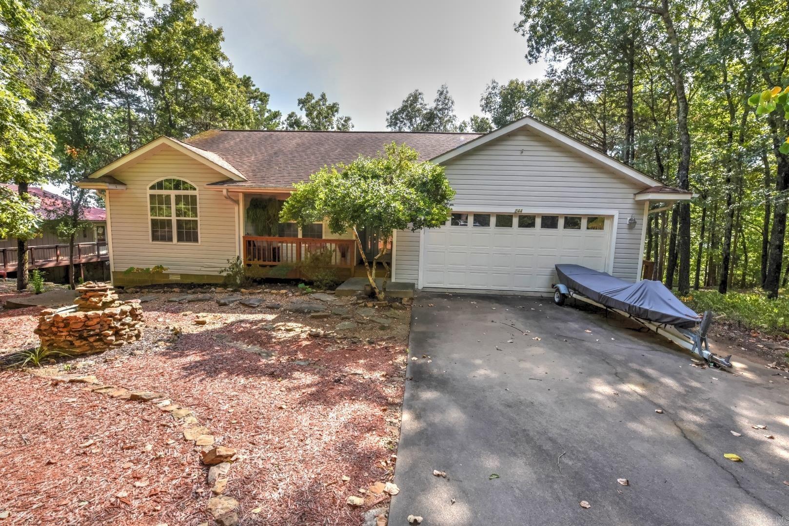 Wake to sweeping Greers Ferry Lake views from this peaceful retreat above Lynn Creek. Enjoy morning coffee on the covered deck, gather with friends around the stone firepit at sunset, and launch your boat just down the roadāabout 5 minutes to Fairfield Bay Marina. The walk-out basement is ideal for a workshop and storage, and extra luxury vinyl plank flooring for the bedroom conveys. One bedroom is currently set up as a music room, offering flexible space for hobbies or a home office. Two additional lots are included, giving you elbow room today and potential for a future shop or outbuildings. Youāre minutes to Indian Hills and Mountain Ranch golf courses and the amenities of Fairfield BayāATV trails, pickleball, tennis, and miles of hiking. Itās a hike to the shoreline, but the big-water and Lynn Creek views make every day feel like vacation. Panoramic views of Greers Ferry Lake. Schedule your appointment to see this home. Additional lots could be sold if not needed but they are currently replatted into one lot providing 1.76 acres. Buyers would need to contact corp of engineers to get path permitted for new owner.