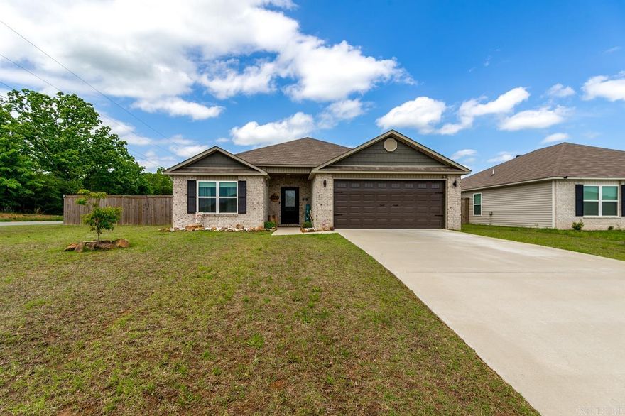 Nearly new 4-bedroom, 2-bath home in Homestead at the Gap offering 1,896 sqft on a desirable 0.21-acre corner lot. The open floor plan features an electric fireplace and flows into a spacious kitchen with granite countertops, a large island with breakfast bar, and oversized pantry. LVP flooring runs throughout all living and wet areas with carpet in the bedrooms, and ceiling fans are included in every bedroom.  The primary suite offers double vanities and an oversized walk-in closet. Enjoy outdoor living on the oversized covered back porch overlooking the beautifully landscaped yard with a fully fenced 6-foot wooden privacy fence. Solar panels provide outstanding energy efficiency, and the seller reports no electric bill for over a year. Additional features include a dedicated laundry room and two-car garage. Located at a Conway address in the Vilonia School District, this home offers a peaceful setting just outside of town while still being only minutes from shopping, dining, and entertainment.