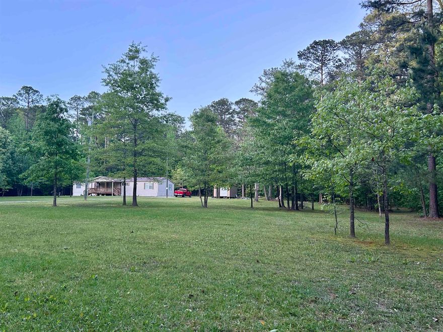 Love watching deer?   Looking for wooded land?   Looking for privacy?   Here it is!  This well maintained home is nestled among 6.61 acres of mixed hardwoods and pines.  So private, yet it's just a couple miles from the highway and quick access to I-30.  This comfortable and spacious home features a split floor plan with large primary bedroom, which is currently being used as a game room.   The primary bathroom has double sinks,  soaking tub, separate shower and walk-in closet.  The living area features a wood-burning fireplace for those cold winter nights, large windows for natural light and wildlife viewing, a corner office and is open to the kitchen.   The kitchen has no shortage of cabinets or counter space and offers a breakfast bar and built-in glass door hutch.   Other amenities include new water heaters, laundry room, metal roof, leaf guard gutters, covered front porch, permanent foundation and storage building.   See agent remarks.