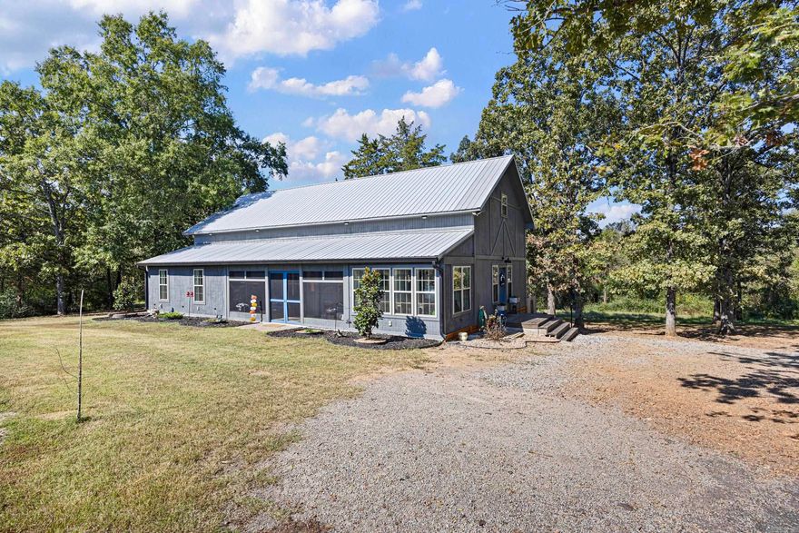 LUXURY MEETS COUNTRY LIVING ā OFF COUNTRY CLUB ROAD! A rare find: +/-12.05 acres of private, scenic land inside Clarksville city limits. This modern farmhouse blends upscale design with everyday comfortāvaulted ceilings, laminate and ceramic floors, and an open, light-filled layout. Smart features include motion-sensor and recessed lighting, a PurVac central vacuum system with ports in every room, solar exterior lights, and Rockville surround sound throughout the home and pool area. The primary bath features a walk-in shower with a tinted picture window showcasing wooded views while maintaining full privacy. Enjoy the sunroom or screened porch overlooking the stocked 3-acre pond and dock. Outside includes a pool, pool house, and 30Ć36 insulated workshop (2023) with electric, mini-split, and garage door. Built in 2018 with a metal roof, HVAC, and water heater from the same year. Fully fenced with a nearly year-round creek, attic space can be modified for a third bedroom, and a fiberglass deer stand for bow hunting conveys. Acreage, technology, luxury, and location rarely align like thisāa one-of-a-kind retreat! Seller offering up to $1,200 for a home warranty of the buyerās choice.