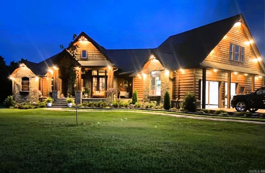 No. 25006 Step into a masterpiece of craftsmanship and comfort at this 4290 sq ft gem, nestled on 1.11 acres at the end of a peaceful cul-de-sac in the prestigious Indian Knob subdivision.  Just 2 minutes from downtown Mountain View, this home blends rustic elegance with modern luxury. Exterior highlights:  Stunning western cedar and native stone facade.  Picturesque exterior lighting enhancing its charm.  Full house generator for peace of mind.  Enclosed porch with an outdoor kitchen, grill, and seated bar for year-round entertaining.  Back deck with composite decking for longevity.  Interior Features: 5 fireplaces, adding warmth and ambiance. Exquisite architectural details, including: A wood barrel ceiling in the family room, an inverted gazebo wood ceiling in the breakfast area, custom built interior doors throughout.  Formal living and dining rooms with soaring 21 ft ceilings and semi-open concept.  A sumptuous master suite with custom tile and woodwork, a walk-in closet featuring detailed wood accents and specialty niches, and a spa-like bath. Central vacuum system for effortless cleaning, two-car garage. 4 bedrooms, 3.5 baths, and so much more.