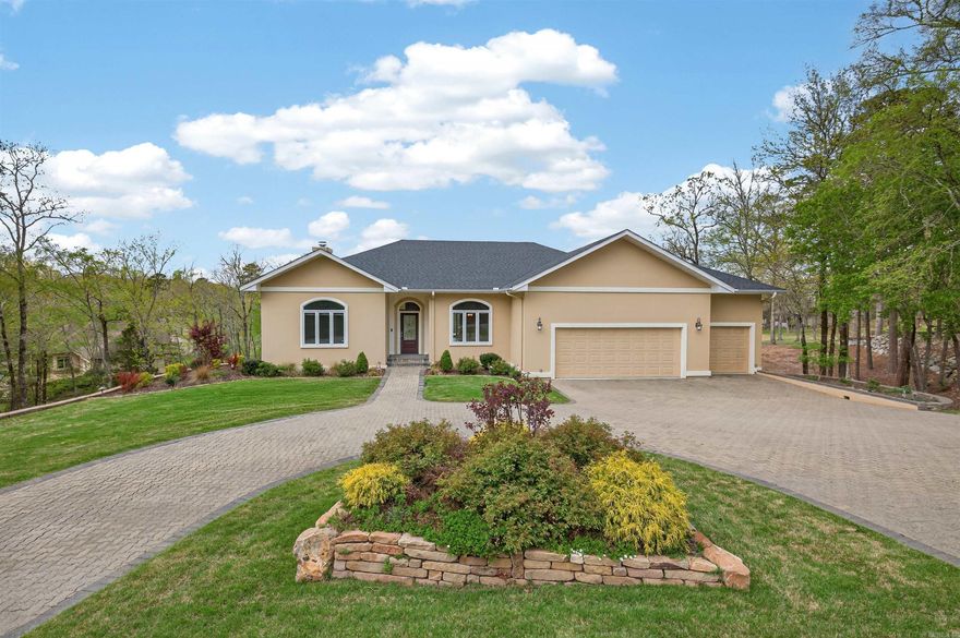 With stunning views of holes #3 and #4 along with a pond and fountain, literally from anywhere in the home, you are sure to enjoy this completely updated 3,100 square foot beauty!  The main level includes everything you need for easy living and entertaining - an oversized family room, eat-in kitchen with breakfast bar, formal dining room, heated and cooled Arkansas room, spacious master suite, a separate guest suite, and an oversized 3-car garage freshly painted with new epoxy coating.  Downstairs you will find a large living room, 3rd guest bedroom, full bath, office/study/storage area, and a separate golf cart garage.  Some of the updates include flooring, interior and exterior paint, new appliances, lighting, security system, sliding doors, roofing, and unbelievable landscaping with a new state-of-the-art sprinkler system.  It's priced right and move-in ready on nearly an acre!  Call today for your private tour - 501.912.4575!