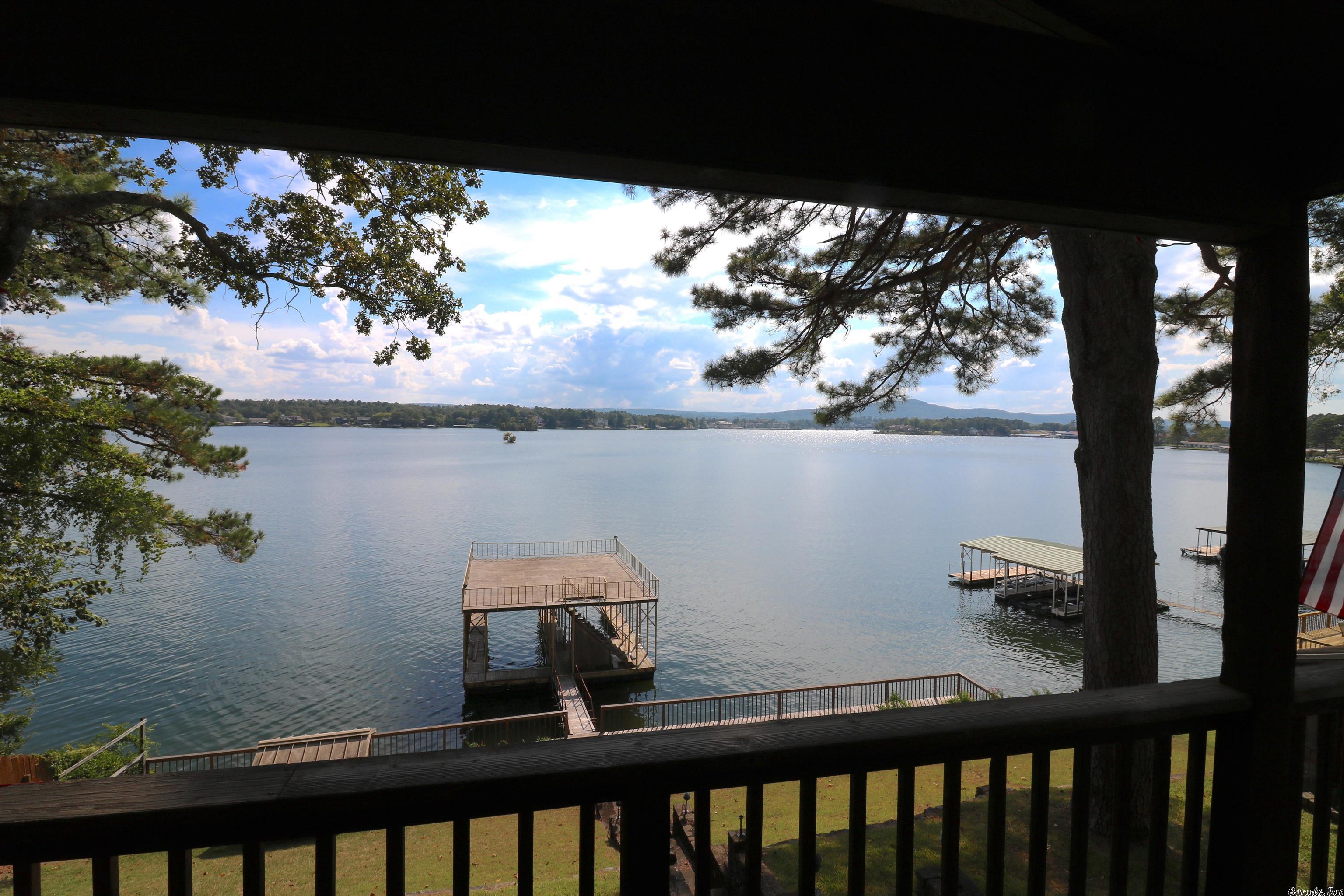 Begin/end your day looking at an breathtaking veiw of the lake w/ a backdrop of the mountains This roomy stone & wood home boasts of 2 decks & 2 family areas on the main level w/ a 3rd dwn stairs Wake up to the gorgeous view through the glass doors in the master bdrm & the family room on same level Workout area has Steam room/shower combo & jetted tub Lounge on the top of your covered dock w/ 2 boat slips Top it off with being just minutes from Shopping restaurants theater & other family fun entertainment