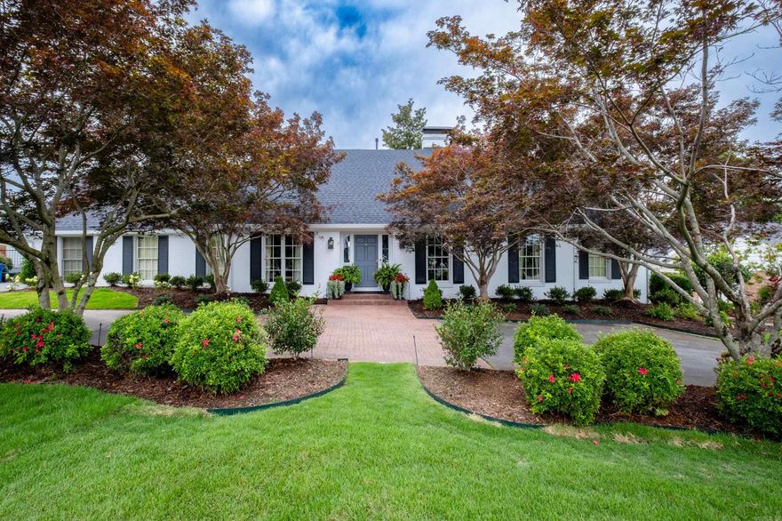 Situated on a beautifully landscaped lot at just over 2/3 of an acre, this timeless four bedroom home is a perfect blend of traditional elegance with modern convenience. Multiple living spaces offer plenty of room for entertaining, including a separate dining room, formal living room, den & sunroom. Two bedroom suites are located on the main level. The primary suite is a true retreat, featuring its own gas fireplace, separate sitting room, luxurious en-suite bathroom with tub & walk in shower, two spacious walk-in closets & custom cabinetry throughout. The kitchen is a masterpiece of classic style & functionality.  Rich, site-laid hardwood floors extend throughout. Dacor 6 burner gas range, double ovens & panel-front appliances seamlessly blend into the custom cabinetry, maintaining a clean & sophisticated aesthetic. The backyard  is an outdoor enthusiasts dream, featuring a stunning gunite pool surrounded by lush landscaping, dining & lounge areas, as well as an exquisite heated & cooled 18x22 pool house featuring fold in glass doors providing indoor/outdoor leisure. Once featured in AT HOME magazine, this home strikes the perfect balance between sophistication and casual living.