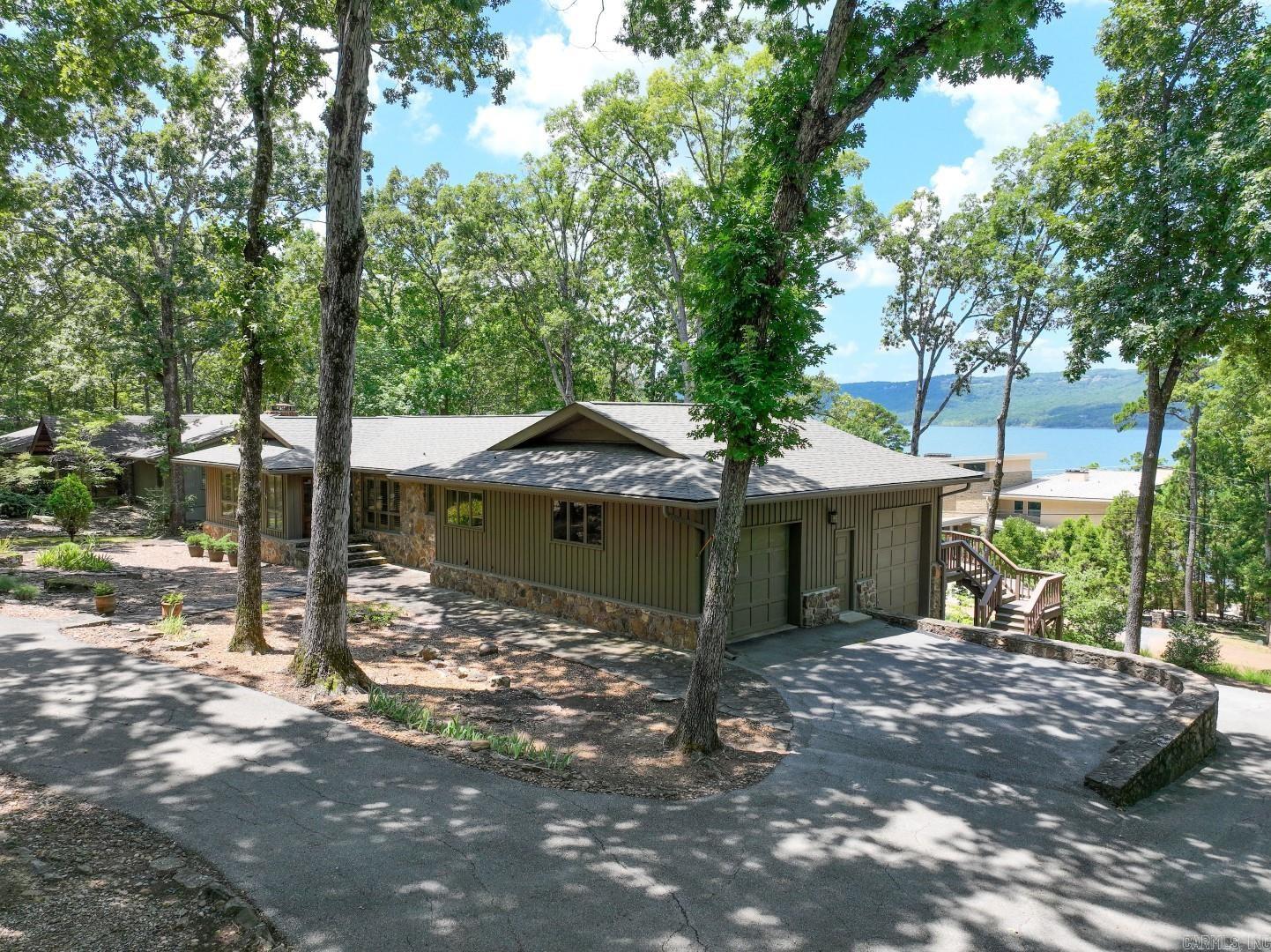 Lovely Eden Isle LAKEVIEW Home (likely designed by Frank McGary) with 5 bedrooms, 3 full baths, 2 living areas, updated kitchen has new large center island with under-counter ice maker and beverage refrigerator, high-end stainless appliances and new cabinetry! New paint and new interior doors, lots of hardwood flooring, cathedral ceilings of beautifully painted tongue & groove wood, walls of glass and a huge deck overlooking Greers Ferry Lake! 2-car garage, updated bathrooms and numerous other improvements! 5 minute golf cart ride to Eden Isle Marina! A wonderful Eden Isle lakehouse!!!