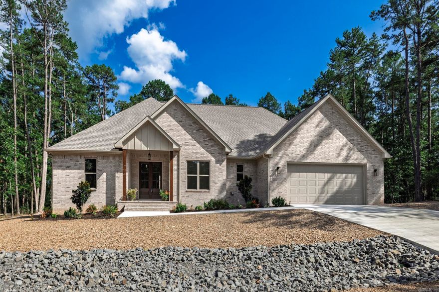 Brand new 2398 square foot home on lovely lot. Trees surround this lovely home with no homes behind. Spacious open floor plan gives you a perfect entertaining area with living, dining and kitchen all connected. You will not be isolated in the kitchen while the family enjoys visiting. Kitchen features a large island and large pantry for your convenience. White cabinetry and counters are an elegant white quartz. Living room opens to an oversized concrete deck perfect for outdoor Village living. Primary bedroom with walk in closet and bath with soaking tub and separate shower. Living area and all bedrooms have a very nice neutral LVP for easy living and low upkeep. Baths feature tile flooring and tub. Three additional  bedrooms complete this modern floor plan. Fourth bedroom would make an excellent office or computer room. Taxes are based on vacant lot. Interior pictures are of recent homes completed by builder. Hot Springs Village boasts 9 golf courses, 11 lakes, pickleball, hiking trails, white sand beach, tennis, fitness center and much more. HSV has one time $2000 buy in for new residents.