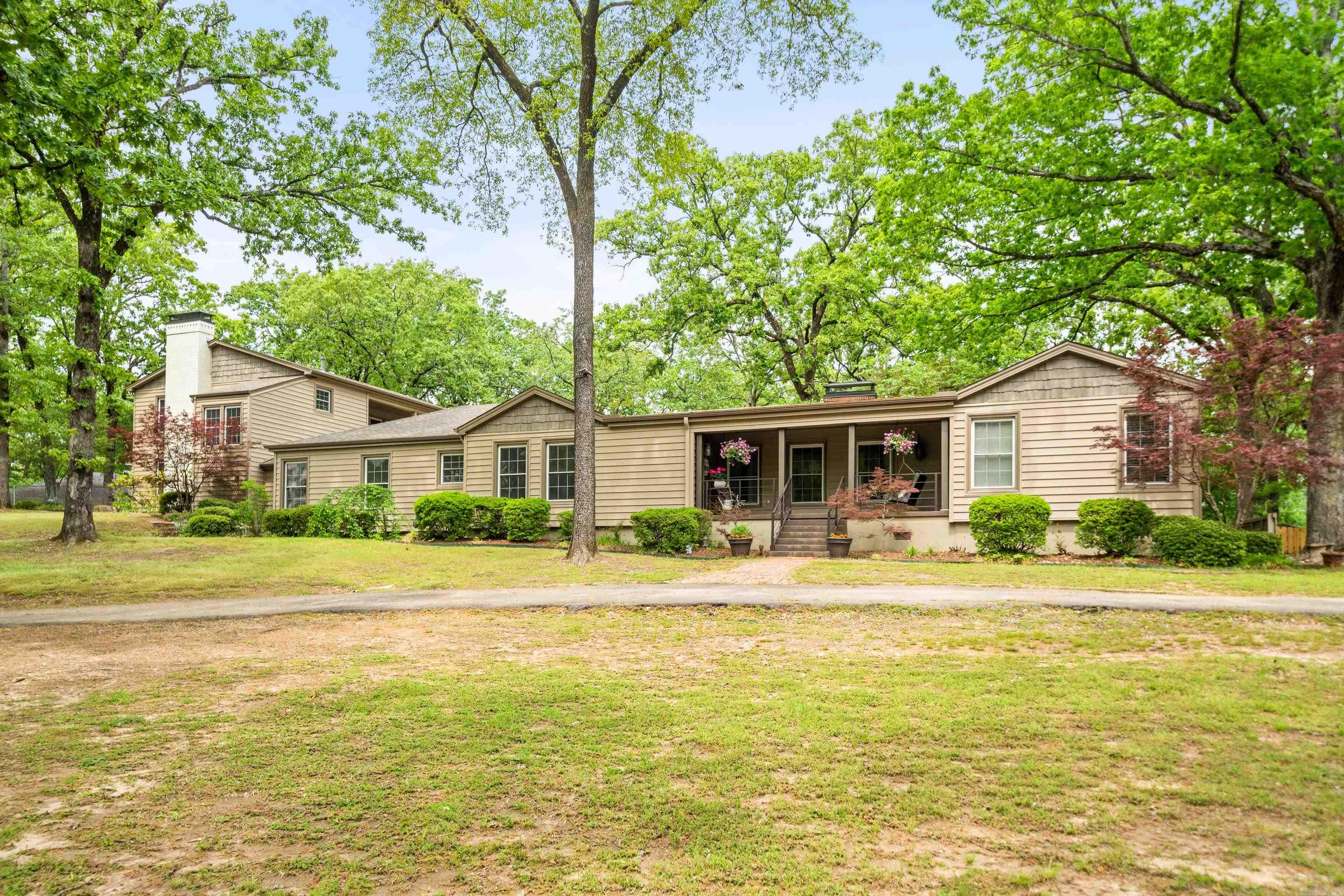Unique opportunity to call this Bellaire Beauty your own! This gorgeous classic boasts just under 5,000 sq. ft. on just over 2 acres nestled in the corner of one of Lakeside School District's most desirably close and convenient neighborhoods. Currently used as triple ensuites, but with a total of 5 bedrooms you have the ability to customize your experience to your necessities or heart's desire! The main level boasts 2 living areas, one with a fireplace and a total of 4 bedrooms plus a sunroom that are updated and pristinely maintained while preserving the character and history of the home. Spacious kitchen den/combo with oversized gorgeous granite island. Subzero refrigerator, gas range and double pantry with ice maker connection. Upstairs is a beautifully done guest quarters above the 2 car garage with a woodburning fireplace with gas starter, kitchenette, and balcony overlooking the gorgeous grounds. The back yard is fully & newly privacy fenced, rear gated entry. Expansive wrap-around patio with a gorgeous outdoor fireplace and fountain area. The outdoor kitchen, hot tub/spa, playhouse and trampoline provide plenty of activities and space for all ages to enjoy. Call today!