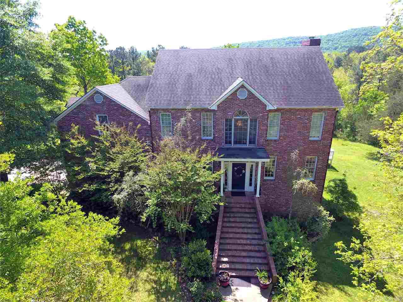 This magnificent property has so much to offer! Just minutes from Lake Hamilton! Main house, approx 4,000 sq ft, Georgian style utilizes historic brick, with mountain views & lush landscaping. The shop features 2 bays & a luxurious guest house with unique bath. Follow the pathway down to the year round creek where you will find the private cabana & hot tub. Almost 50 acres offers green pastures, stocked pond, woods, fruit trees, & refreshing swimming hole. Separate rental with 2 units produces extra income.