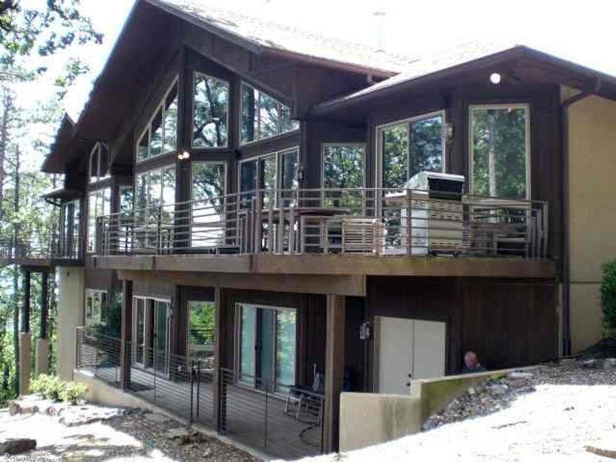 This home is beyond description.  From the deck you can watch the eagles soar from the highest point in the Village across Lakes Balboa and Lago to the gorgeous peaks of the Ouachita Mountain range in the distance.  This home has everything that one can imagine and it is all waiting for someone to enjoy.  In addition to all the standard features found in a luxury home, this one has an entire guest suite attached which includes a complete kitchen, a laundry room and attached garage.  All appliances convey.