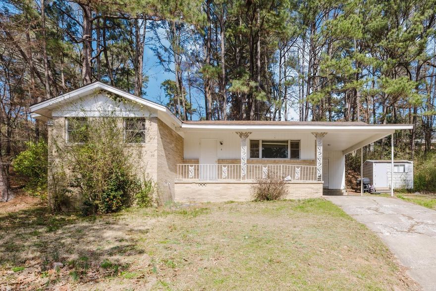 **Charming Mid-Century Ranch with Great Potential**  This classic mid-century ranch offers timeless character and a wonderful opportunity to make it your own. Situated on a spacious, tree-lined lot, the home features original hardwood floors, abundant natural light, and vintage details throughout.  The generously sized kitchen includes solid wood cabinetry, ample counter space, and a cozy breakfast bar. Well-proportioned bedrooms provide comfortable living space and plenty of sunlight.  Outside, enjoy the brick exterior, covered front porch, extended driveway, and carport. The large yard offers room to garden, entertain, or relax.  Perfect for first-time buyers, investors, or anyone looking to personalize a home with great bones—schedule your showing today!