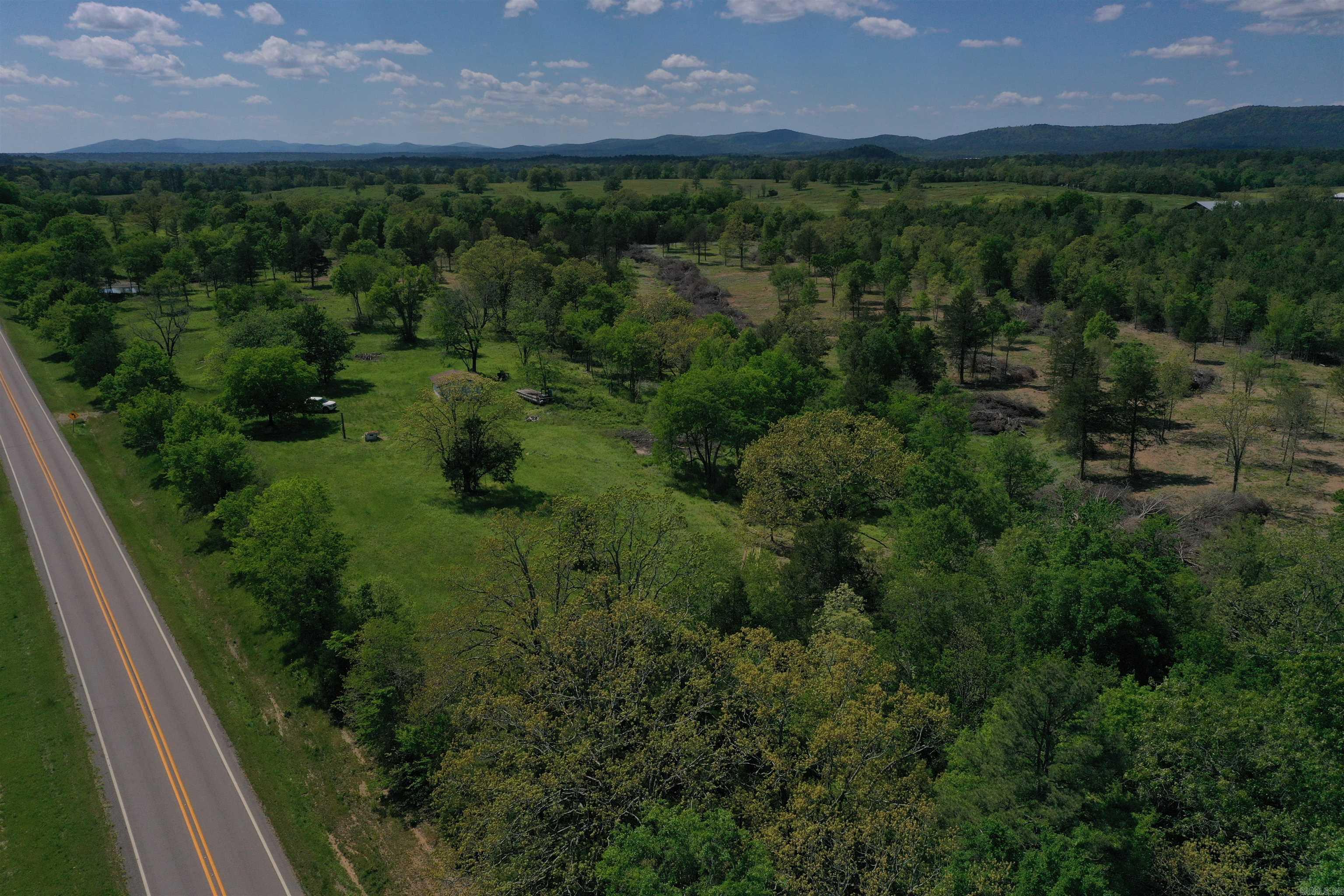 This Montgomery County acreage has great views and is in an even better location! The 11 +/- acres spans across rolling topography, with great views from the build sites along the hilltop. A water well is already in place, and power is available at the Highway. The cleared acreage is beautiful from front to back, and even has a pond. Along with being a beautiful build site, this property has an excellent location as well. Dragover Recreation area on the Ouachita River is just a few minutes’ drive down the county road, providing access to one of the most unique canoeing and fishing opportunities on the river. This section of the river offers a multiple hour float, that ends within walking distance of the parking area! The Ouachita National Forest is just minutes away as well, offering hundreds of thousands of acres of public land, with many great opportunities for hunting, fishing, hiking, and enjoying The Natural State. If you enjoy spending time on the lake, an access and boat ramp for Arkansas largest lake, Lake Ouachita, is just 15 minutes away.
