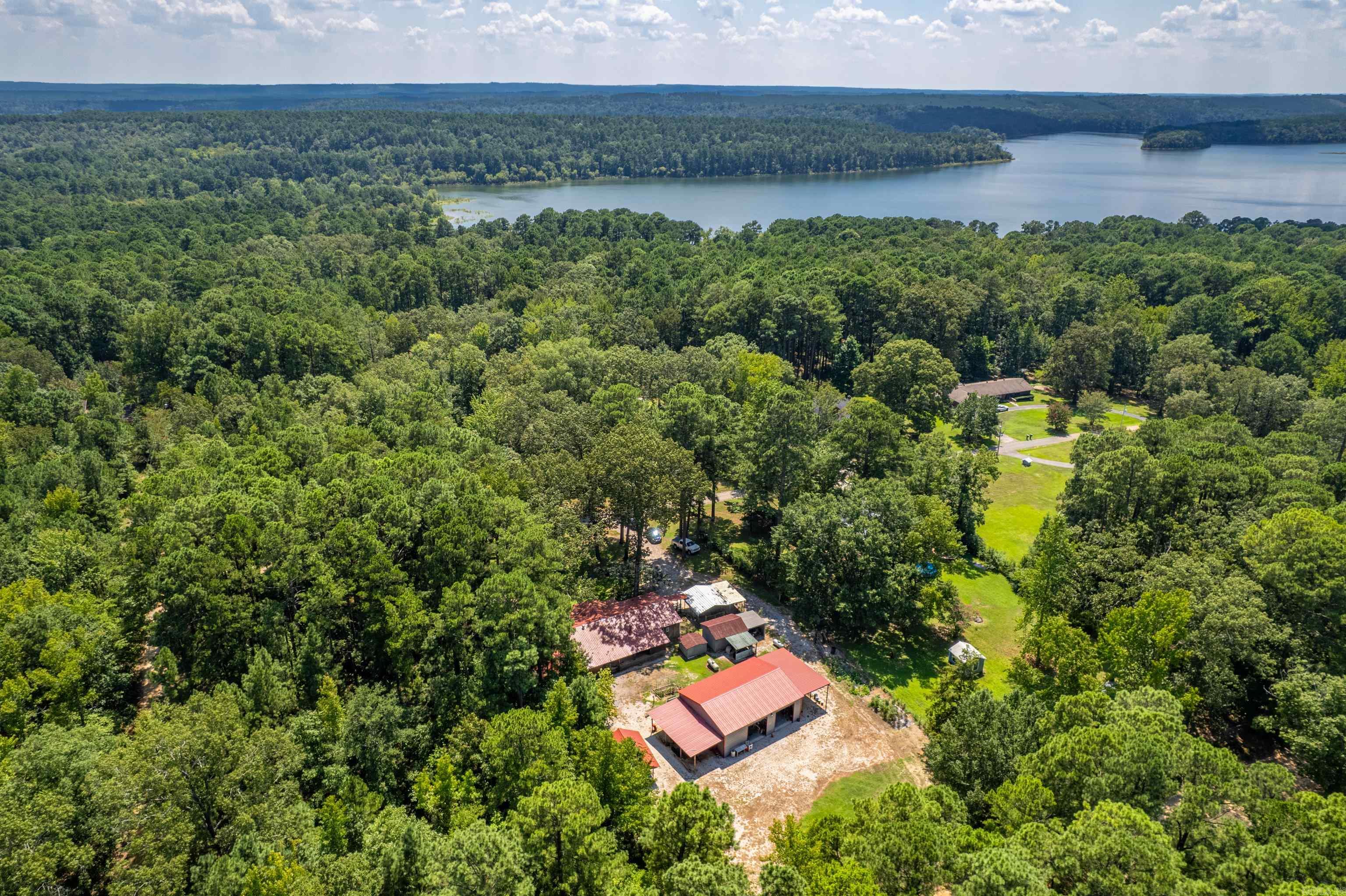 This property is a great Lake DeGray get away or a forever home! Sitting on two lots, it hosts a 1,568 sq foot 3-bedroom 2 bathroom double wide home with attach front and back porches, a 30 X 40 metal shop with electric, storage building and multiple other side-sheds. Great property and at a great price! Call today for a showing.